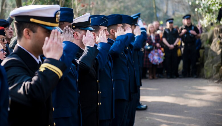 Members of the U.S. Air Force, Navy, and Army render a salute to the Mi Amigo memorial at Sheffield, United Kingdom, February 24th, 2019. This year’s annual memorial service was accompanied by a United States Air Force and Royal Air Force flypast in Endcliffe Park two days prior, where thousands of U.K. residents honored the memory of ten fallen U.S. Airmen who died when their war-crippled B-17 Flying Fortress crash landed to avoid killing residents and nearby children. (U.S. Air Force photo by Tech Sgt. Aaron Thomasson)