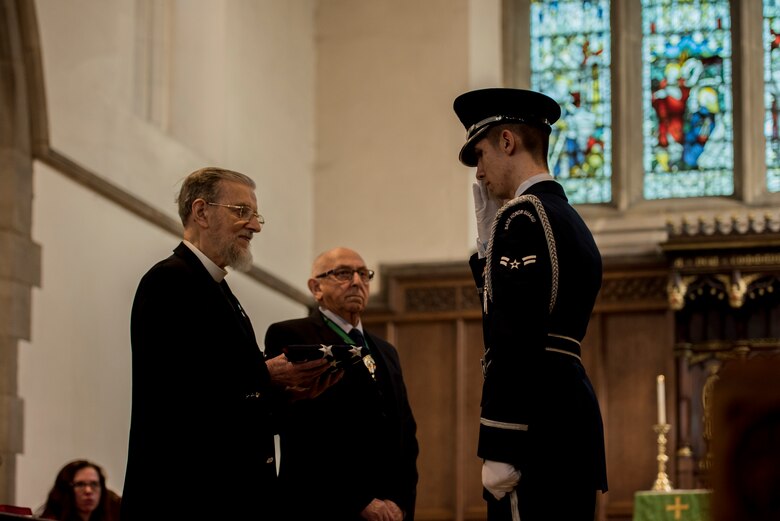 U.S. Air Force Airman First Class Joshua Holsing salutes after presenting the American flag to Reverend Gordon Unsworth at St. Augustine’s Church in Sheffield, United Kingdom, February 24th. This year’s annual memorial service was accompanied by a United States Air Force and Royal Air Force flypast in Endcliffe Park two days prior, where thousands of U.K. residents honored the memory of ten fallen U.S. Airmen who died when their war-crippled B-17 Flying Fortress crash landed to avoid killing residents and nearby children. (U.S. Air Force photo by Tech Sgt. Aaron Thomasson)