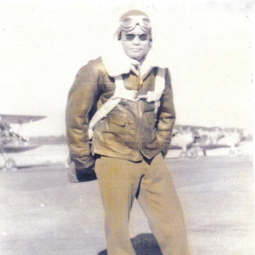 Franklin Macon stands for a photo in his flight suit