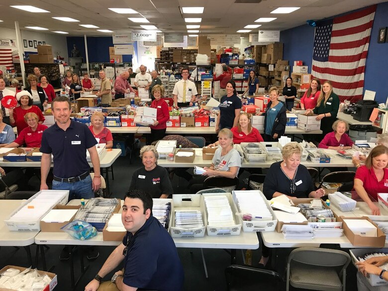 For the Troops volunteers who put together and package the care boxes military members and civilians receive while deployed in Afghanistan and Iraq.