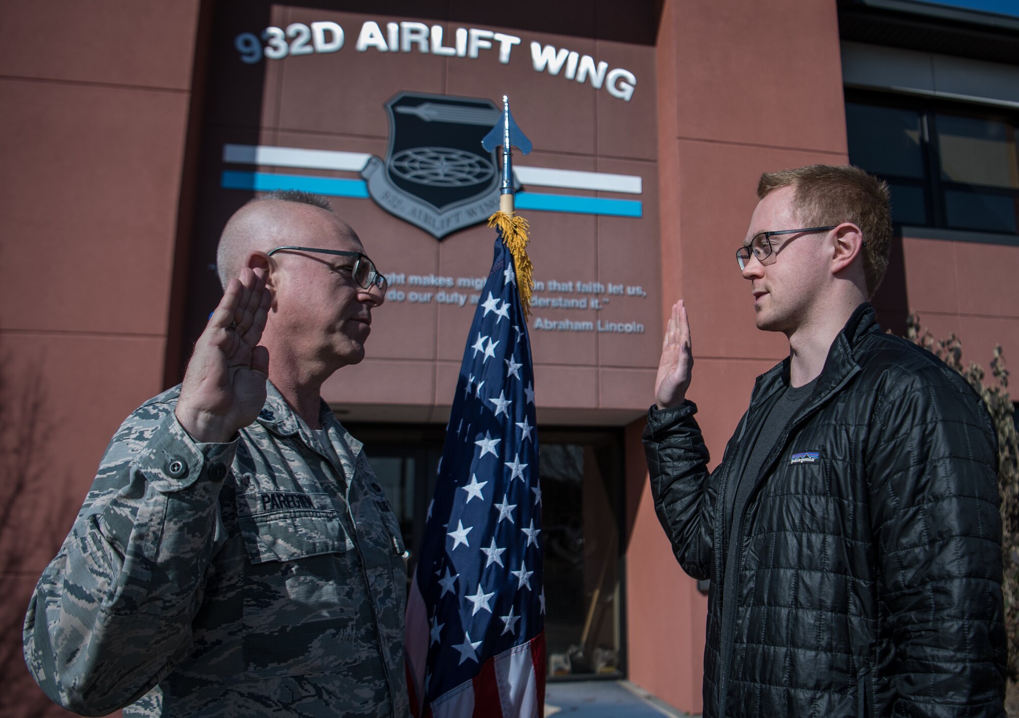 Enlisting into the U.S. Air Force Reserve Command is Casey Earl, right, being given the oath of enlistment by Lt. Col.Stan Paregien, 932nd Airlift Wing Public Affairs Officer, Feb. 25, 2019, 932nd AW headquarters building, Scott Air Force Base, Illinois. Earl will be an E-5, Staff Sgt. For a short time and then begin his Air Force journey to becoming an officer in Cyber Operations. “I chose the Air Force Reserve because it positioned me for great opportunities that matched my civilian career,” said Earl about why he became a citizen Airman.  (U.S. Air Force photo by Christopher Parr)