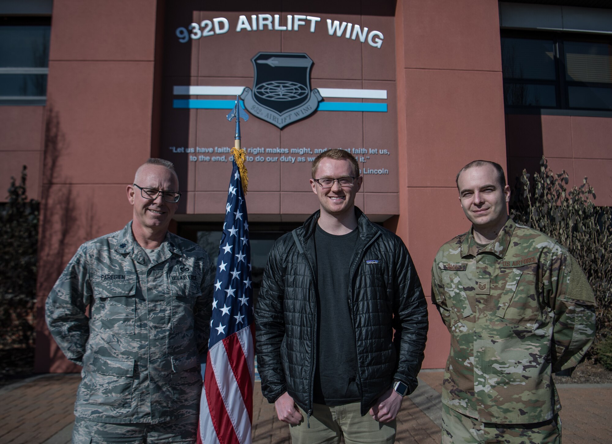 New Air Force citizen Airman, Casey Earl, center, poses with Air Force recruiter, Tech. Sgt. Michael Smith, right, and  Lt. Col.Stan Paregien, 932nd Airlift Wing Public Affairs Officer, following Earl's oath of enlistment, Feb. 25, 2019, Scott Air Force Base, Illinois. Earl looks forward to getting through all the training and certifications for cyber operations and then getting in and doing the job. (U.S. Air Force photo by Christopher Parr)