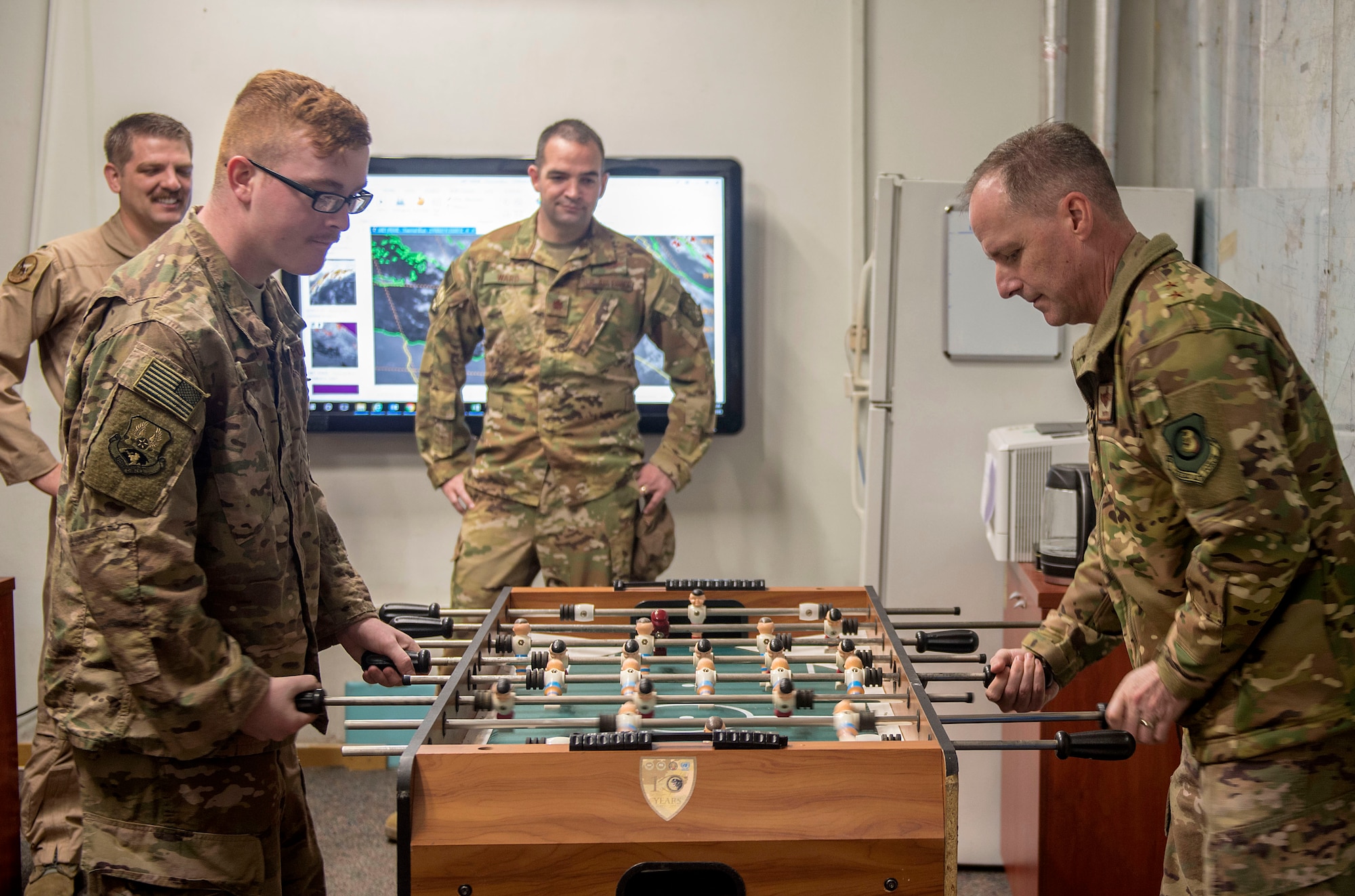 U.S. Air Force Maj. Gen. John M. Wood, Third Air Force commander and U.S. Air Force Senior Airman David Alley, 22nd Expeditionary Air Refueling Squadron weather forecaster, play foosball after an immersion briefing at Incirlik Air Base, Turkey, Feb. 22, 2019.