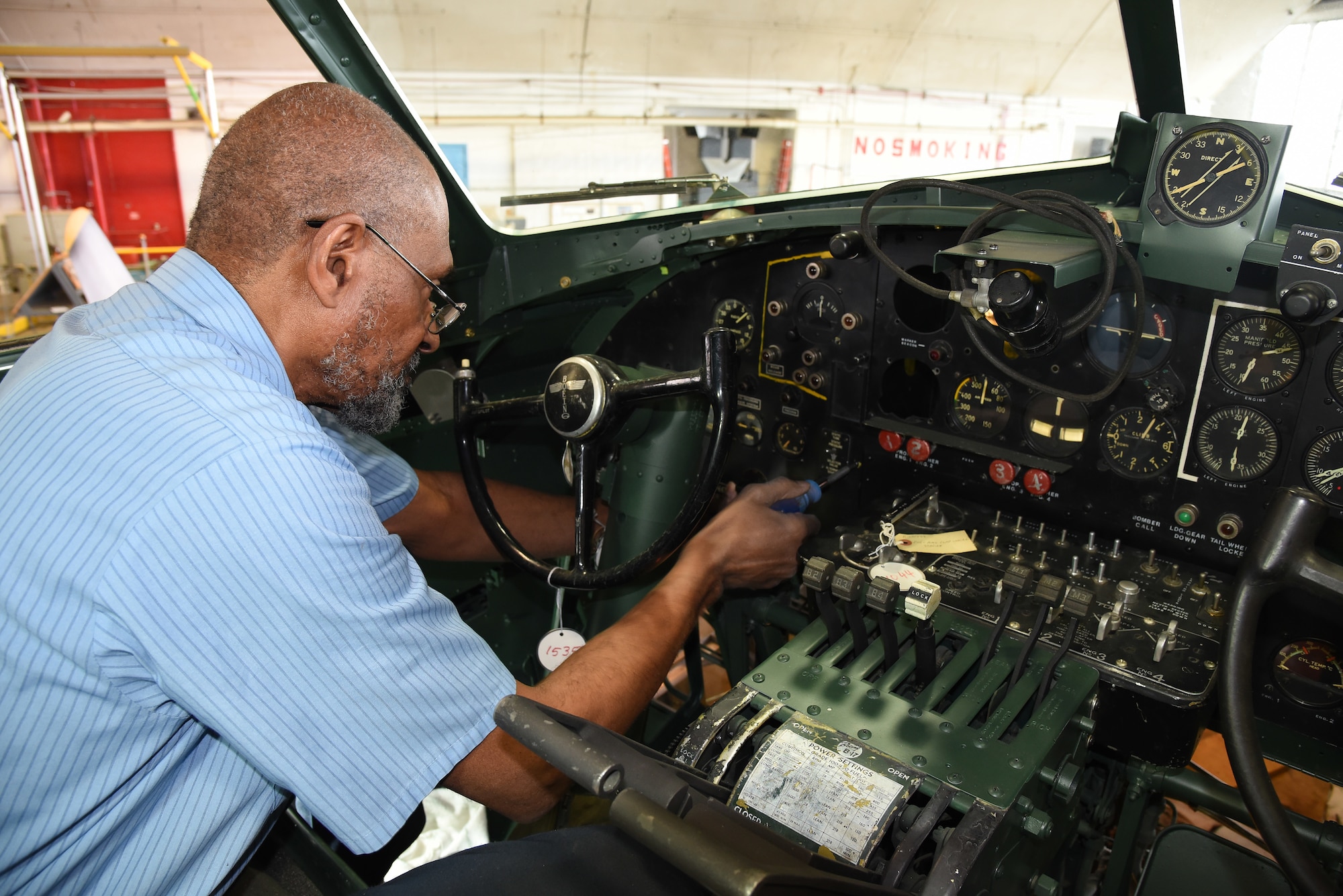 DAYTON, Ohio -- National Museum of the U.S. Air Force restoration specialist Dave Robb installs the pilot's instrument panel on the Boeing B-17F Memphis Belle on March 7, 2018. (U.S. Air Force photo by Ken LaRock)