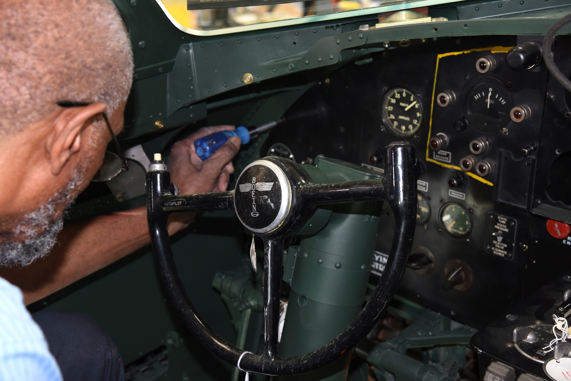 DAYTON, Ohio -- National Museum of the U.S. Air Force restoration specialist Dave Robb installs the pilot's instrument panel on the Boeing B-17F Memphis Belle on March 7, 2018. (U.S. Air Force photo by Ken LaRock)