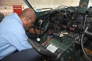 DAYTON, Ohio -- National Museum of the U.S. Air Force restoration specialist Dave Robb installs the pilot's instrument panel on the Boeing B-17F Memphis Belle on March 7, 2018. (U.S. Air Force photo by Ken LaRock)