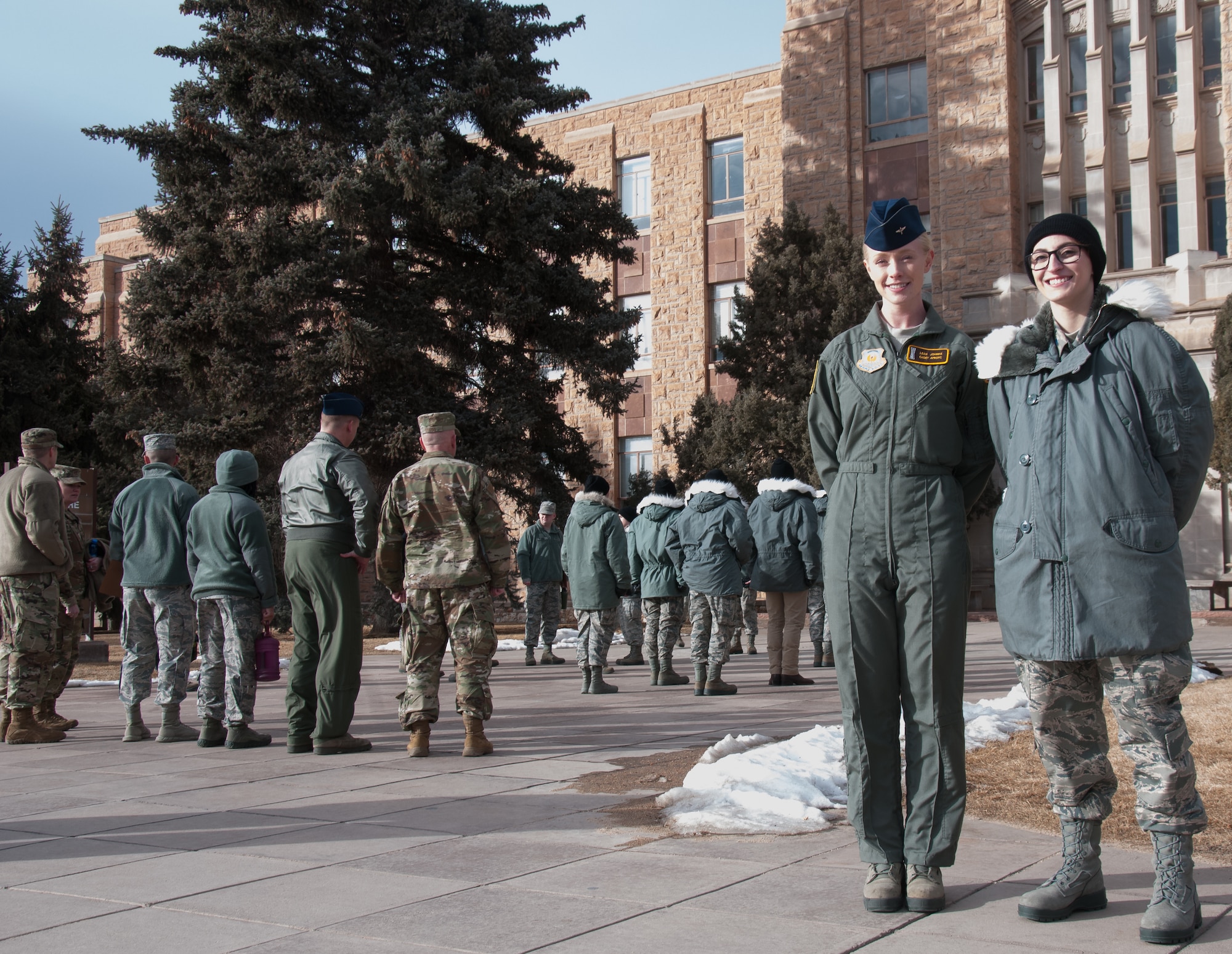 Cadet Leah Johnke and Cadet Victoria Pumilio pose in front of the agriculture building at the University of Wyoming in Laramie, Wyo., Feb. 13 2019.  Pumilio and Johnke are both interested in the missile operations (13N) career field and hope to become active duty officers soon.