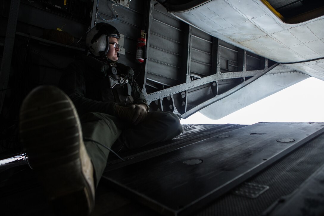 U.S. Marine Sgt. Scott Veck a crew chief assigned to HMH-464, Marine Aircraft Group 29, 2nd Marine Aircraft Wing observes his surroundings above Brunswick, Maine, Feb. 15, 2019. Marine Heavy Helicopter Squadron 464 is participating in a cold weather training exercise. HMH-464 stays ready to operate in cold weather and other austere environments should the need arise. Veck is  (U.S. Marine Corps photo by Cpl. Jered T. Stone)