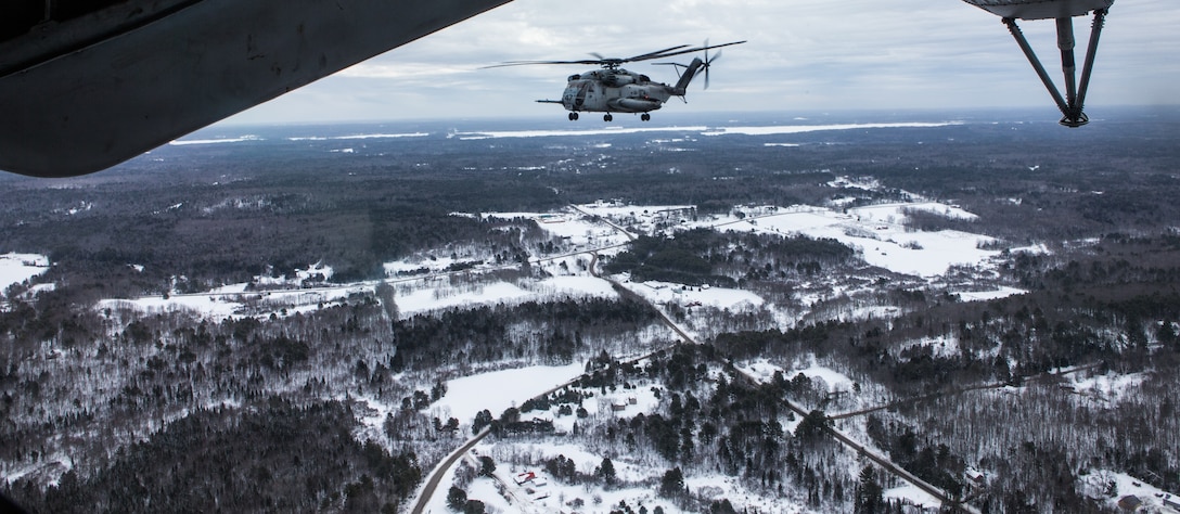 A U.S. Marine Corps CH-53E Super Stallion assigned to HMH-464, Marine Aircraft Group 29, 2nd Marine Aircraft Wing flies above Brunswick, Maine, Feb. 15, 2019. Marine Heavy Helicopter Squadron (HMH) 464 is participating in a cold weather training exercise to familiarize and operate in cold weather and other austere environments should the need arise. The aircraft is  (U.S. Marine Corps photo by Cpl. Jered T. Stone)