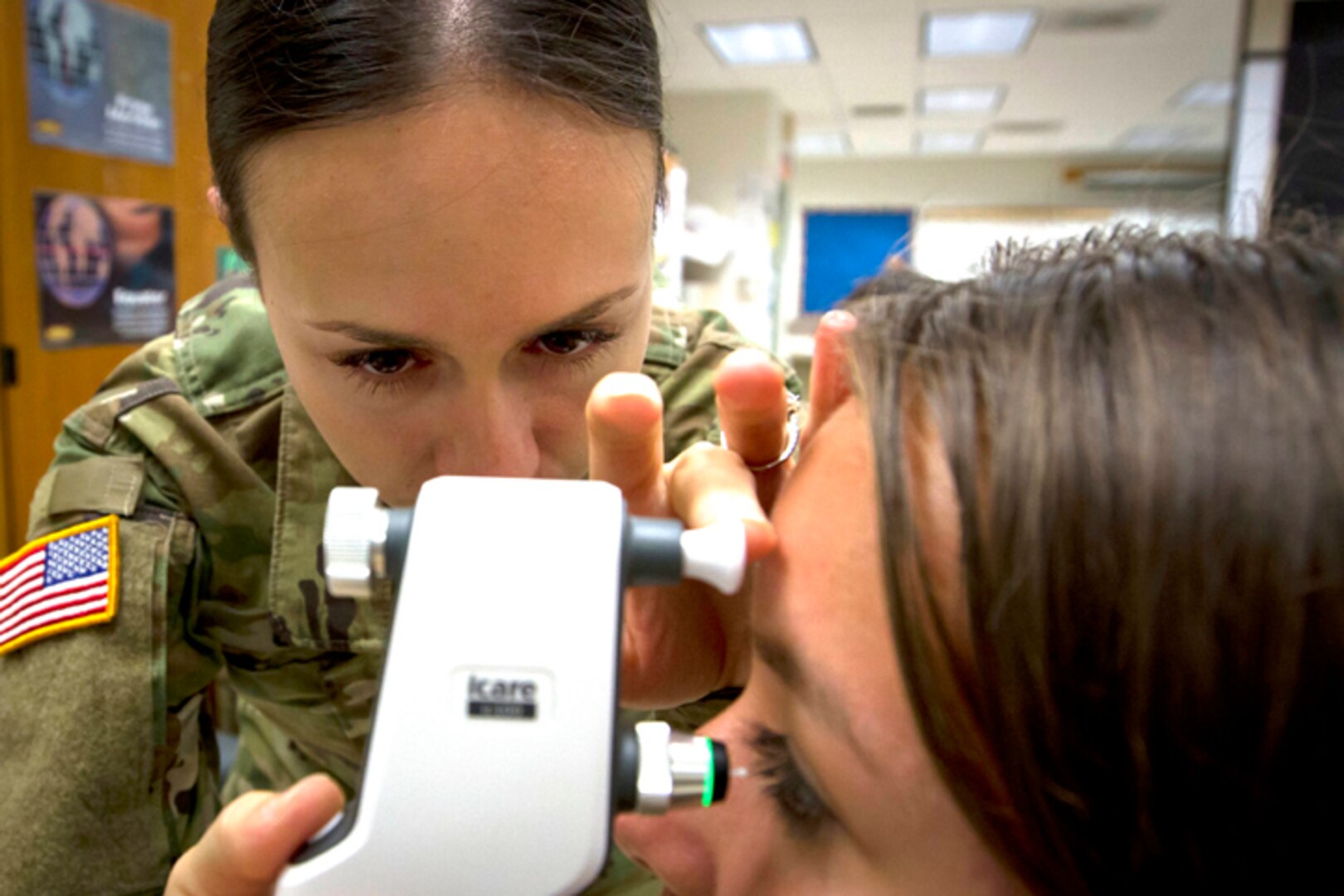 Spc. Brianne Coots, an eye specialist in the U.S. Army Reserve assigned to the 1984th U.S. Army Hospital, 9th Mission Support Command out of Honolulu, Hawaii, performs an eye exam during Tropic Care 2018 in Kea’au, Hawaii, June 24, 2018.
