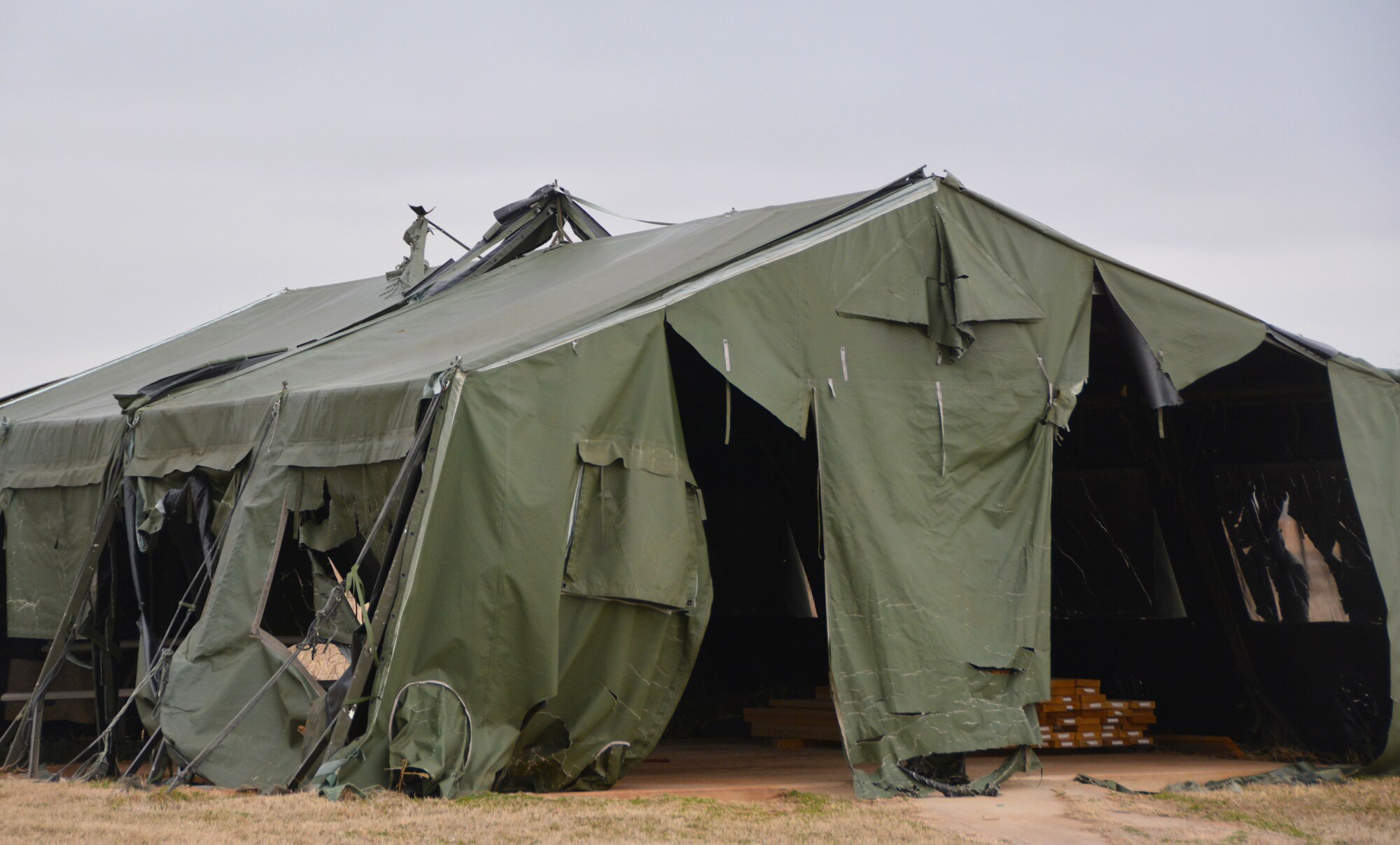 A tent from the Glenwood training area is damaged and weathered here Feb. 26. Members of the 507th Civil Engineer Squadron improved the area by building three new Quonset huts here February 26. The new Quonset huts are more permanent, cheaper, and fully equipped with electric, heating and air. The improvements will make readiness training exercises on the site more efficient, according to members of the wing inspection team. (U.S. Air Force Photo by Maj. Jon Quinlan)
