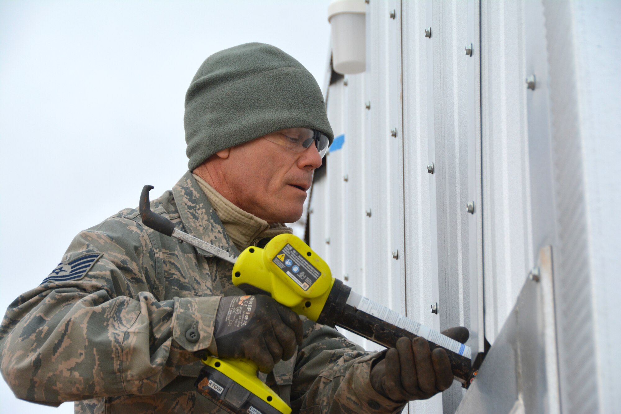 Tech. Sgt. Lyndon Jones, 507th Civil Engineer Squadron works on the final touches of one of the three new Quonset huts at the Glenwood training area here February 26. Reserve Citizen Airmen partnered with the 72nd Air Base Wing to build the huts and repair some damaged facilities at the training area. The new Quonset huts are more permanent, cheaper, and fully equipped with electric, heating and air. The improvements will make readiness training exercises on the site more efficient, according to members of the wing inspection team. (U.S. Air Force Photo by Maj. Jon Quinlan)