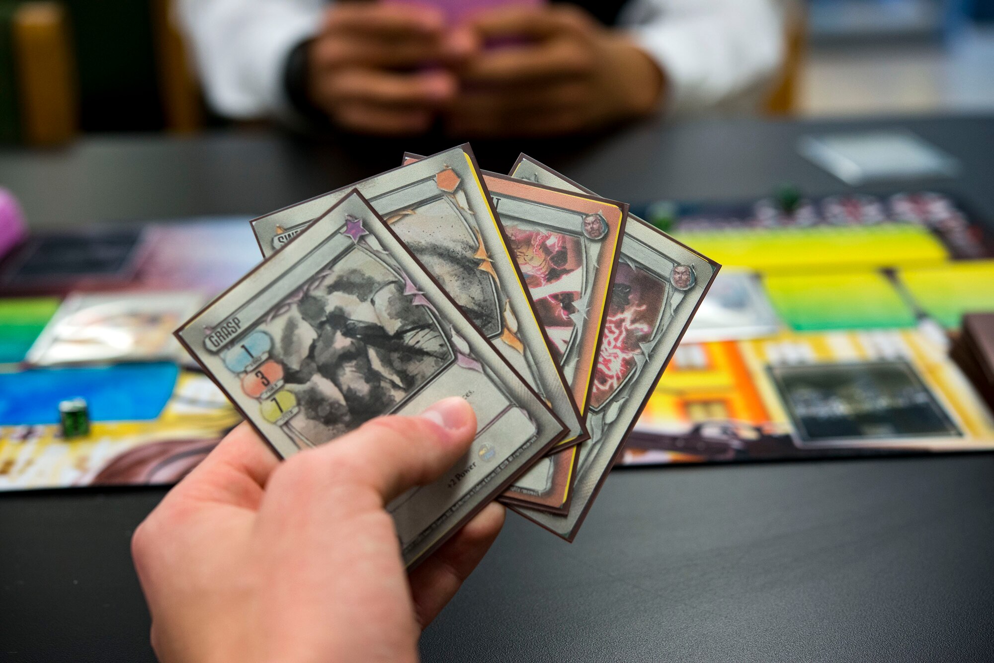 A guest readies his cards while playing a trading-card game during Cub Con II, a multi-genre entertainment convention, Feb. 23, 2019, at Moody Air Force Base, Ga. At the convention, guests were able to participate in board and card games, a video game tournament and a “Star Wars” panel. The event served as an opportunity to give Team Moody a chance to experience the anime and comic book culture. (U.S. Air Force photo by Airman 1st Class Erick Requadt)