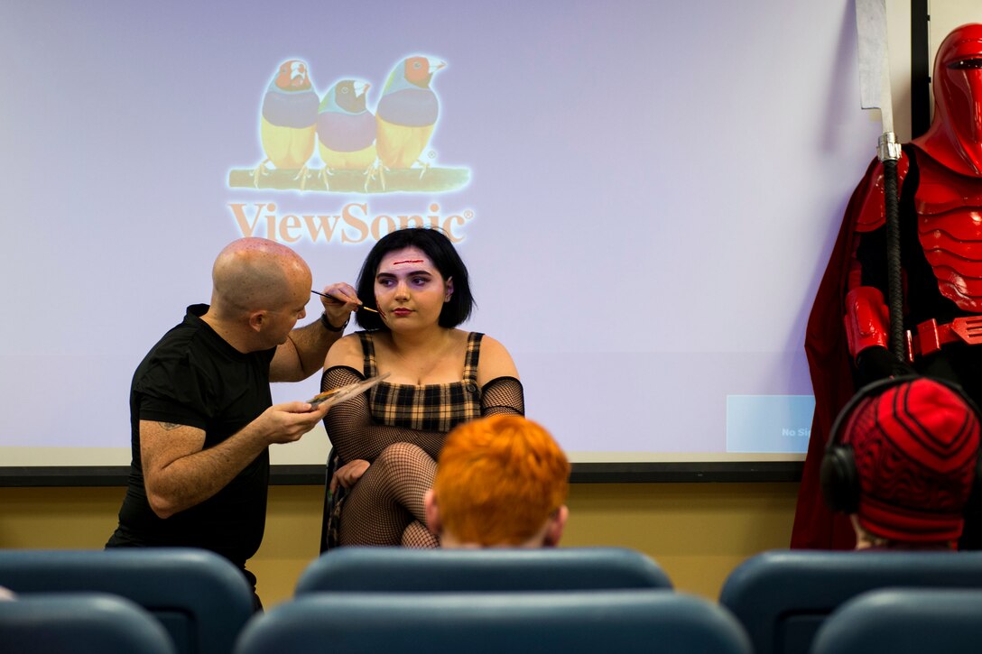 Staff Sgt. William Hannay, left, 723d Aircraft Maintenance Squadron weapons team chief, applies makeup on a guest at a special effects makeup demo during Cub Con II, a multi-genre entertainment convention, Feb. 23, 2019, at Moody Air Force Base, Ga. At the convention, guests were able to participate in a cosplay contest, an anime music video contest, anime trivia contest and special effects makeup demo. The event served as an opportunity to give Team Moody a chance to experience the anime and comic book culture. (U.S. Air Force photo by Airman 1st Class Erick Requadt)