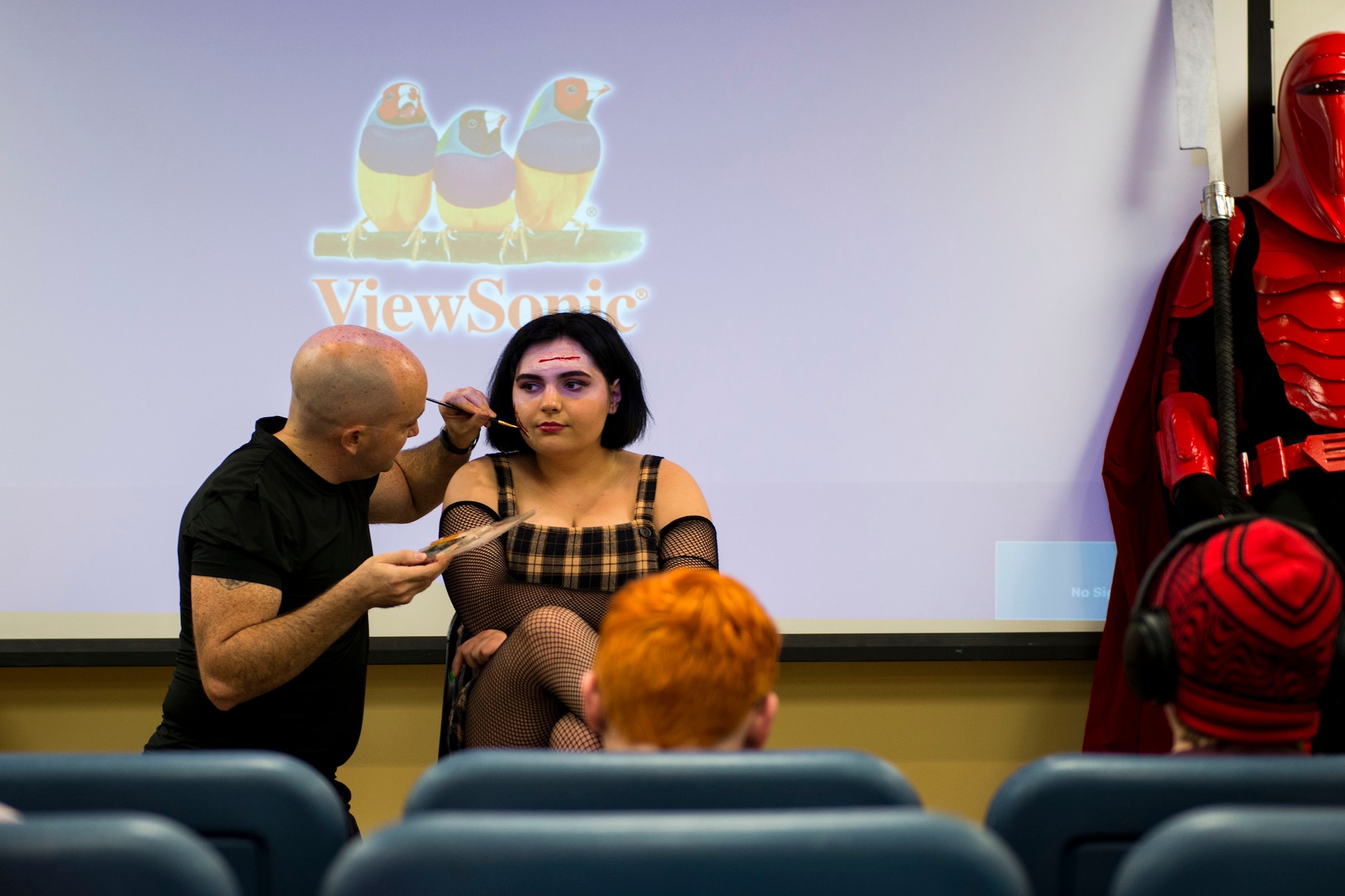 Staff Sgt. William Hannay, left, 723d Aircraft Maintenance Squadron weapons team chief, applies makeup on a guest at a special effects makeup demo during Cub Con II, a multi-genre entertainment convention, Feb. 23, 2019, at Moody Air Force Base, Ga. At the convention, guests were able to participate in a cosplay contest, an anime music video contest, anime trivia contest and special effects makeup demo. The event served as an opportunity to give Team Moody a chance to experience the anime and comic book culture. (U.S. Air Force photo by Airman 1st Class Erick Requadt)