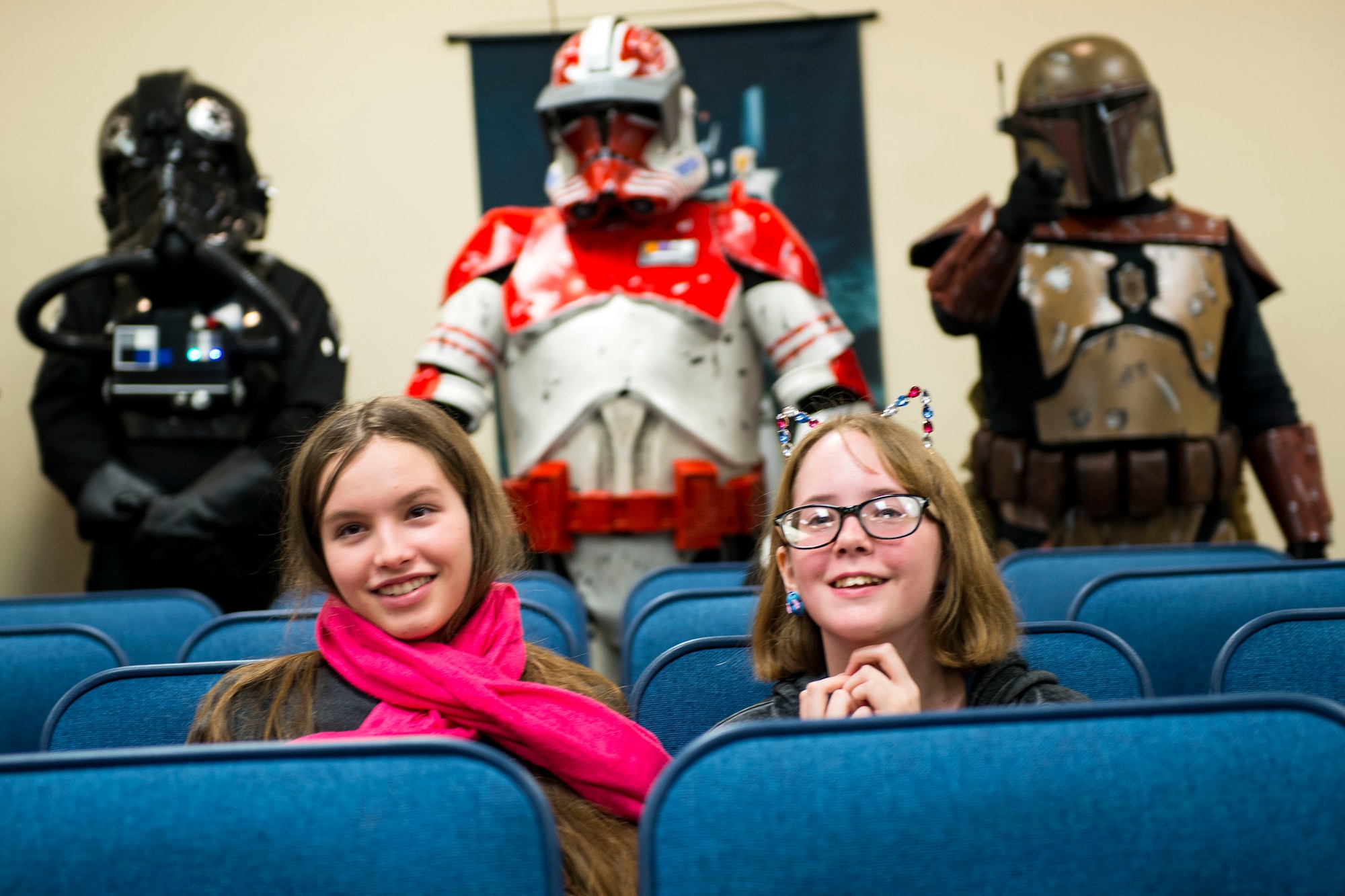 Guests share a smile as they watch a cosplay contest during Cub Con II, a multi-genre entertainment convention, Feb. 23, 2019, at Moody Air Force Base, Ga. At the convention, guests were able to participate in a cosplay contest, an anime music video contest, anime trivia contest and special effects makeup demo. The event served as an opportunity to give Team Moody a chance to experience the anime and comic book culture. (U.S. Air Force photo by Airman 1st Class Erick Requadt)