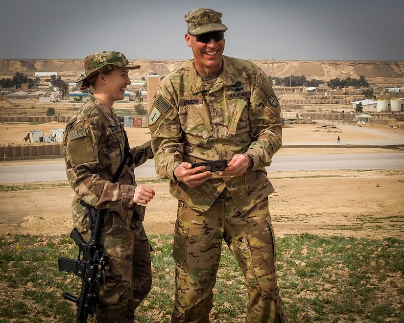 U.S. Army Chief Warrant Officer 5 Joseph Lemens, left, a helicopter maintenance test pilot assigned to the 935th Aviation Support Battalion, Missouri National Guard, and his daughter U.S. Army 1st. Lt. Jordan Lemens, right, a route clearance platoon leader assigned to 2nd platoon, B Co., 326th Brigade Engineer Battalion, pose together for a family photo at Al Asad Air Base, Iraq, Feb. 7, 2019.  Father and daughter, both simultaneously deployed to Iraq, were able to spend a few hours together despite working in different geographic areas.  The 935th ASB and 326th BEB support Combined Joint Task Force-Operation Inherent Resolve, working by, with, and through partner forces to defeat ISIS.