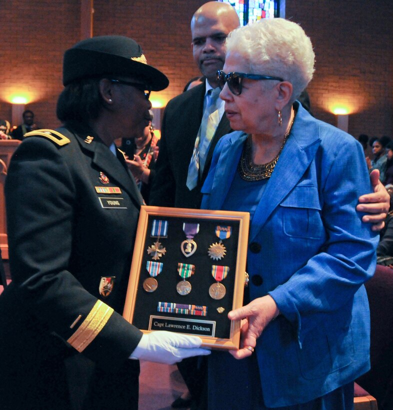 Marla L. Andrews (right), daughter of U.S. Army Air Forces Capt. Lawrence E. Dickson, receives her father’s medals from Brig. Gen. Twanda E. Young, deputy commanding general of the U.S. Army’s Human Resources Command, during a Feb. 24 ceremony held at Fountain Baptist Church in Summit, New Jersey. Dickson was a Tuskegee Airman declared missing in action after his plane crashed in Europe in December 1944. Dickson’s remains were identified in November 2018 using the latest DNA tests, making him the first to be identified out of more than two-dozen Tuskegee Airmen declared MIA during World War II.