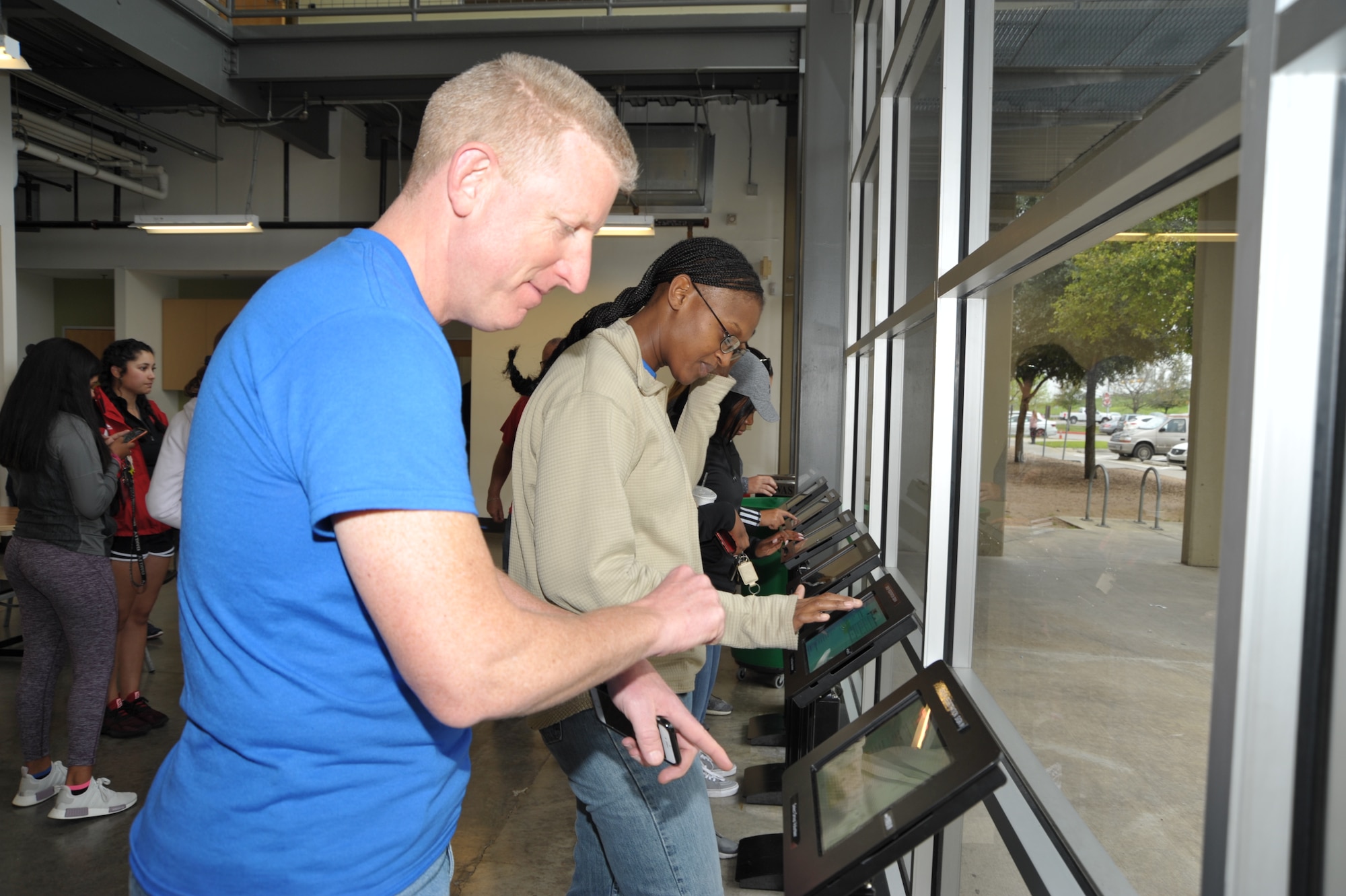 Senior Master Sgt. Craig Pfister, 340th Flying Training Group inspections superintendent, and Master Sgt. Faith Wells, 340th financial services section chief, sign in to the San Antonio Foodbank prior to the 340th FTG community support activity held Feb. 22. The 340th team and fellow volunteers sorted and packed more than 10,000 pounds of food. (U.S. Air Force photo by Debbie Gildea)