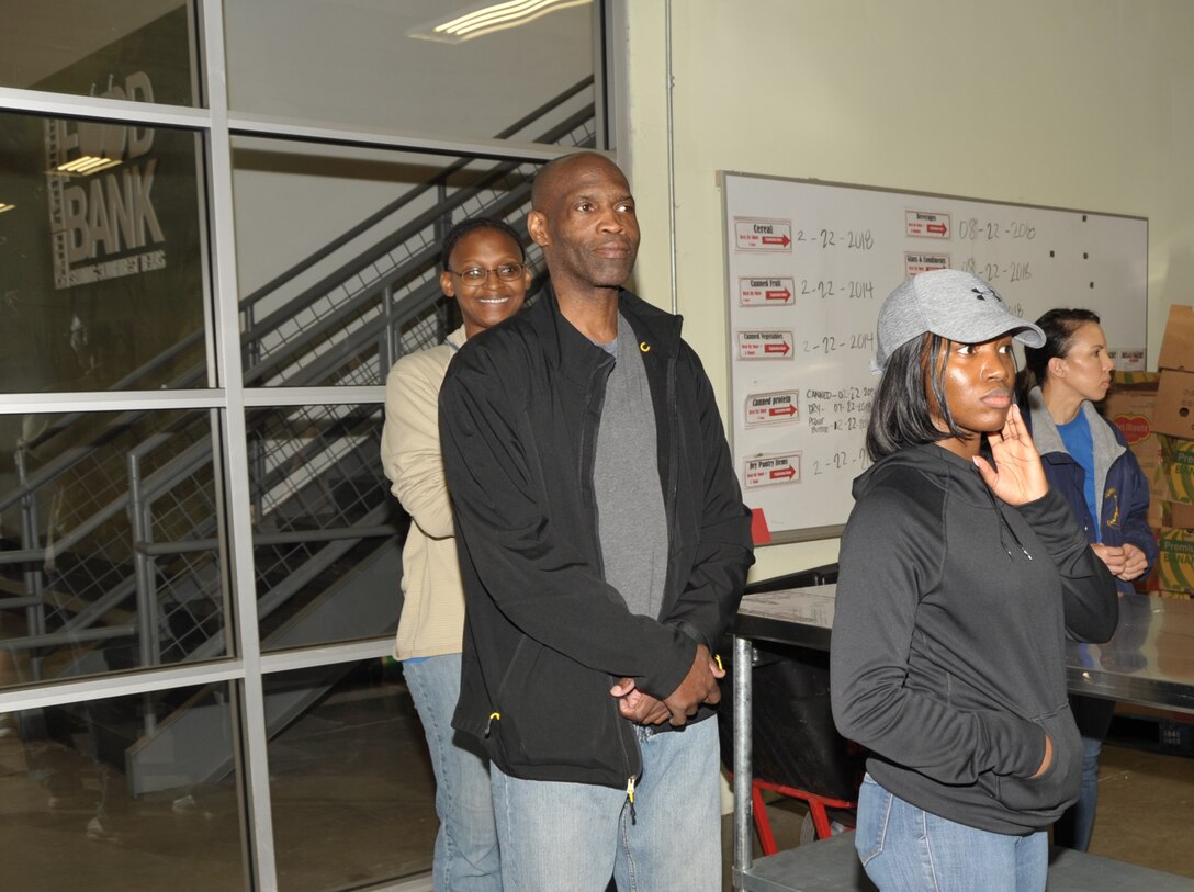 SA Foodbank volunteers Master Sgt. Faith Wells, Senior Master Sgt. Kwame Tawiah, Tech. Sgt. Shakeeta Thomas and Master Sgt. Angelina Manby listen to the volunteer coordinator’s instructions before they begin sorting donated food during the 340th FTG community support activity held Feb. 22. The 340th team and fellow volunteers sorted and packed more than 10,000 pounds of food. (U.S. Air Force photo by Debbie Gildea)