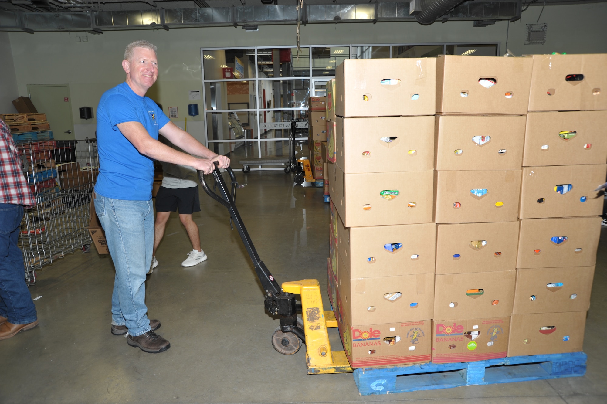 Senior Master Sgt. Craig Pfister, 340th inspections superintendent, prepares to haul a palette of sorted food to the warehouse during the 340th FTG’s Feb. 22 community outreach event in support of the San Antonio Foodbank. Together, the 340th team and fellow volunteers sorted and packed more than 10,000 pounds of food and non-food items, including pet supplies. (U.S. Air Force photo by Debbie Gildea)