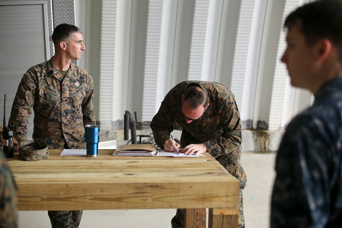 Master Sgt. Jordan Johnson and Chief Warrant Officer 3 Scott Carter prepare for a brief on the explosive ordnance range aboard Marine Corps Air Station Beaufort, Feb. 19. Johnson is the Staff non-commissioned officer in charge and Carter is the officer in charge of MCAS Beaufort EOD.