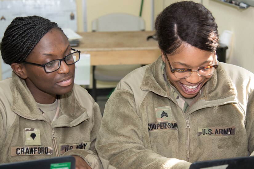 Specialist Marticha Crawford, left, and Sgt. Denay Cooper-Smith, both students at Camp Buehring, Kuwait's Basic Leader Course, work together during a small group exercise Feb. 16, 2019. “Working together helps build comradery among all of us; it also helps us complete tasks more efficiently,” said Crawford.