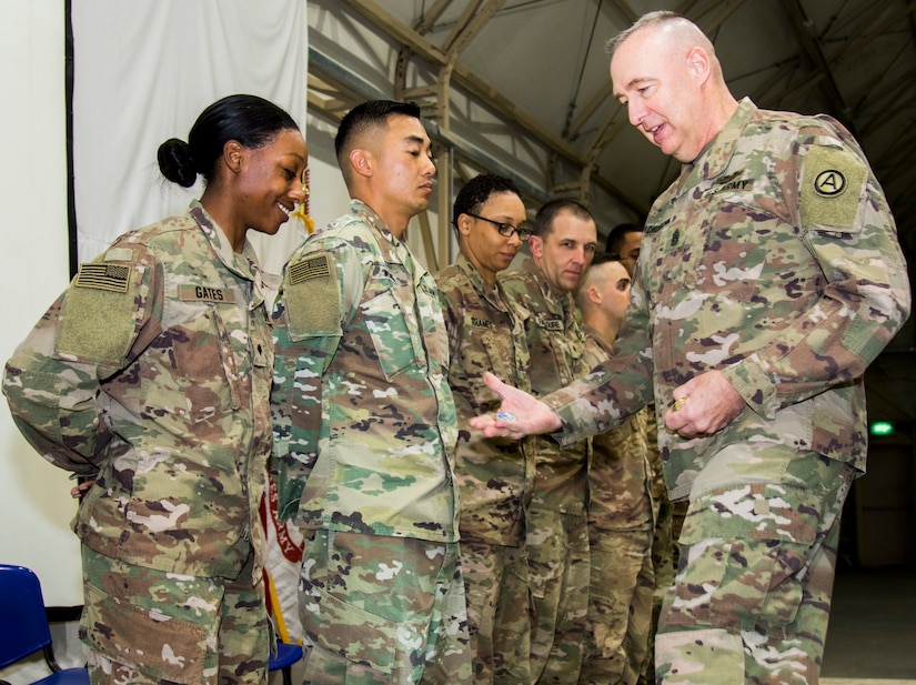 Command Sgt. Maj. Dan Churchman, commandant, Basic Leader Course, Camp Buehring, Kuwait, presents a Commandants Coin to Spc. Shannon Gates, far left, Company A, 106th Brigade Support Battalion, 155th Armored Brigade Combat Team, Mississippi Army National Guard, who is from Magee, Mississippi, for earning BLCs distinguished honor graduate, Feb. 19, 2019. Distinguished honor graduate is awarded to the student who holds the highest overall grade point average throughout the course.