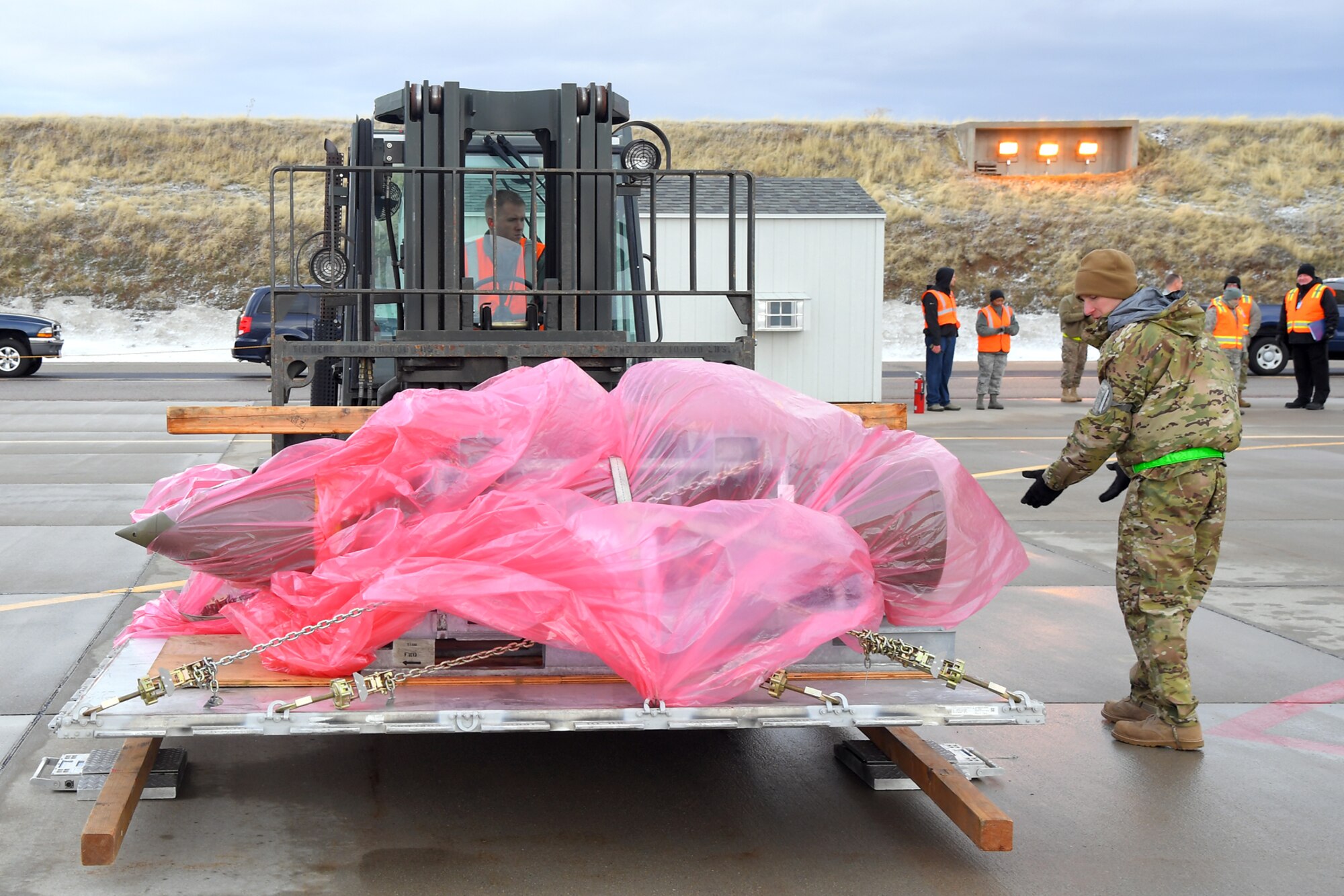 Staff Sgt. Daniel Sargent (right) spots Staff Sgt. Marcus Renfrow, 75th Logistics Readiness Squadron, moving cargo during a readiness exercise, Feb. 5, 2019, at Hill Air Force Base, Utah. During the exercise, Airmen were assessed on performing different tasks to improve their operational readiness. (U.S. Air Force photo by Todd Cromar)