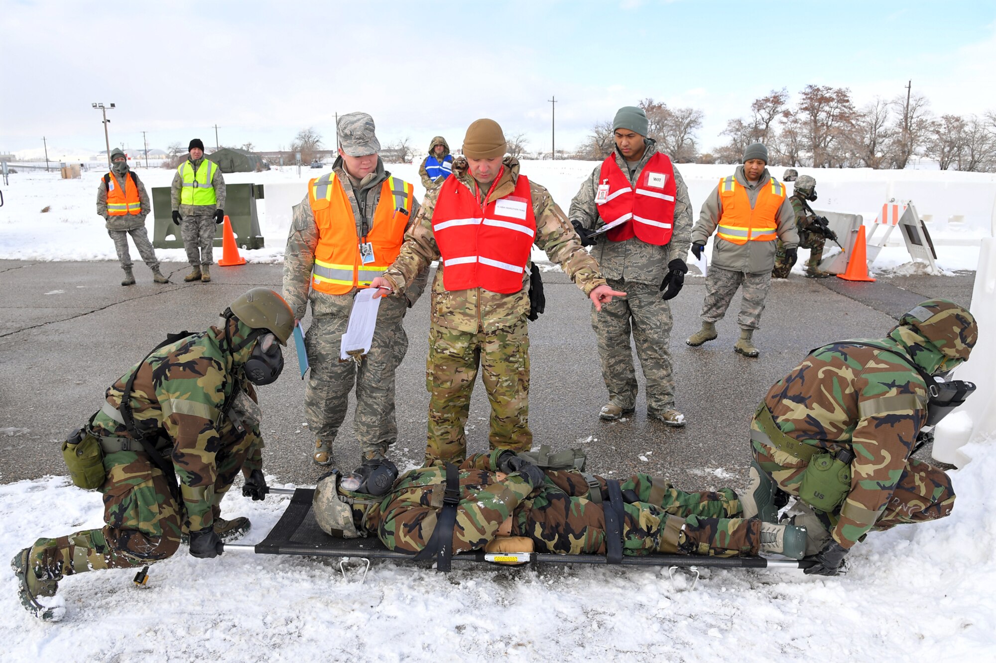 Wing inspection team members evaluated Airmen carrying a patient with simulated injuries during a readiness exercise, Feb. 7, 2019, at Hill Air Force Base, Utah. During the exercise, Airmen donned mission-oriented projective posture, or MOPP, gear and were assessed on performing different tasks in a simulated toxic environment to improve their operational readiness. (U.S. Air Force photo by Todd Cromar)