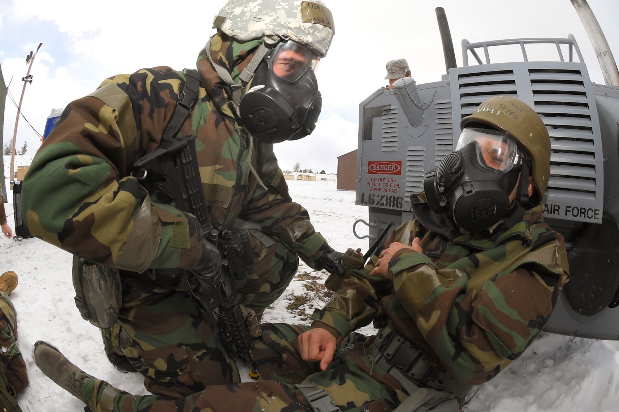 Staff Sgt. Nicholas Lowery, 75th Security Forces Squadron, provides assistance to Tech. Sgt. Marvin Teyes, 75th Air Base Wing, during a readiness exercise, Feb. 7, 2019, at Hill Air Force Base, Utah. During the exercise, Airmen donned mission-oriented projective posture, or MOPP, gear and were assessed on performing different tasks in a simulated toxic environment to improve their operational readiness. (U.S. Air Force photo by Todd Cromar)