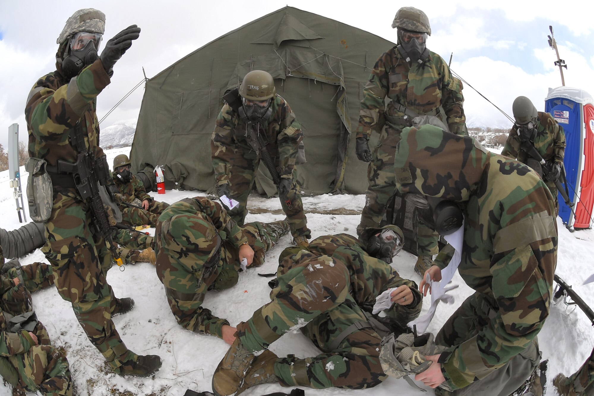 Airmen attend to patients with simulated injuries during a readiness exercise, Feb. 7, 2019, at Hill Air Force Base, Utah. During the exercise, Airmen donned mission-oriented projective posture, or MOPP, gear and were assessed on performing different tasks in a simulated toxic environment to improve their operational readiness.  (U.S. Air Force photo by Todd Cromar)