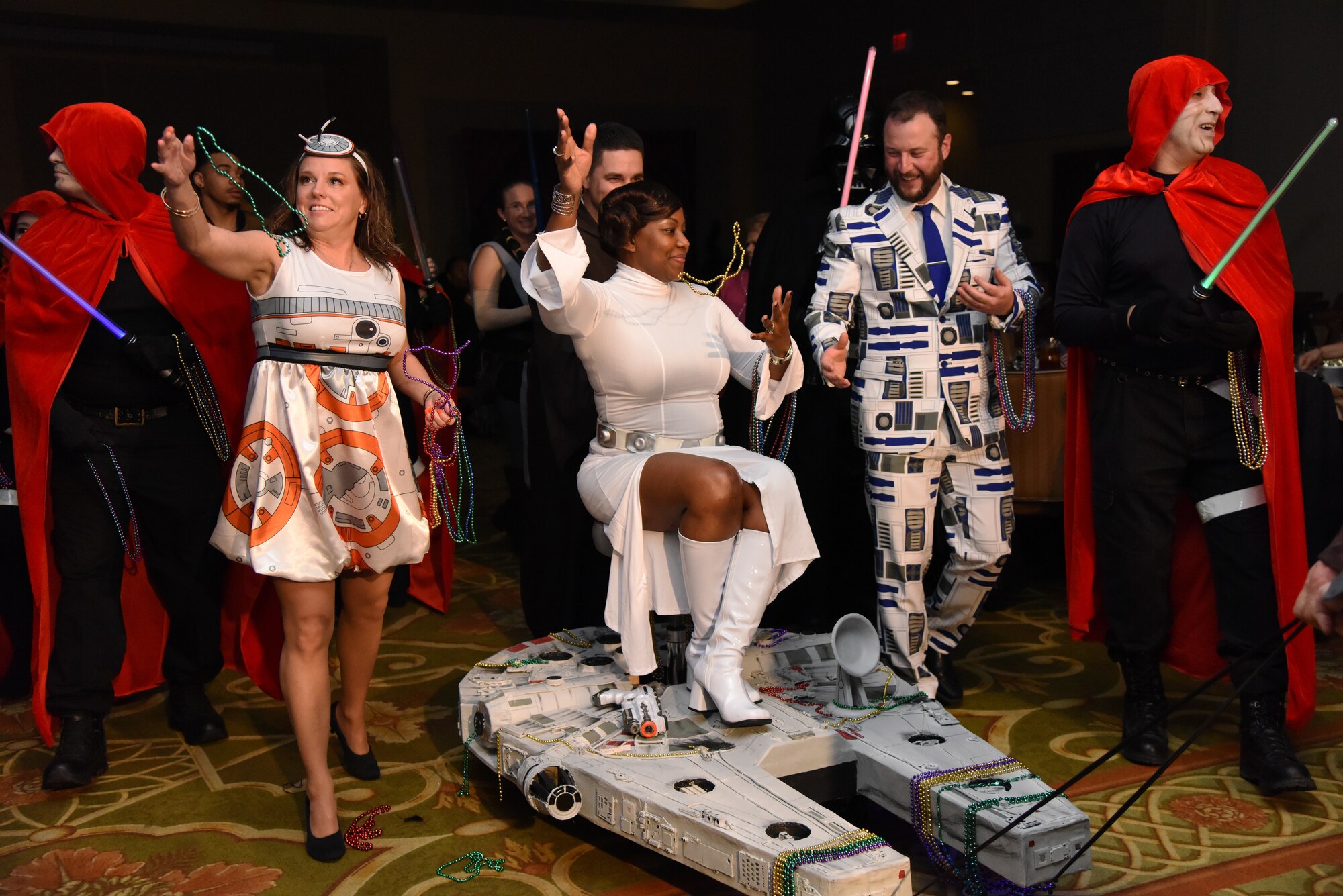 Members of the 81st Surgical Operations Squadron portray the Star Wars cast as they make their way down the aisle during the 31st Annual Krewe of Medics Mardi Gras Ball at the Bay Breeze Event Center on Keesler Air Force Base, Mississippi, Feb. 23, 2019. The Krewe of Medics hosts a yearly ball to give Keesler Medical Center personnel a taste of the Gulf Coast and an opportunity to experience a traditional Mardi Gras, which is celebrated by the local communities. The theme for this year's ball was Hollywood vs. Broadway. (U.S. Air Force photo by Kemberly Groue)