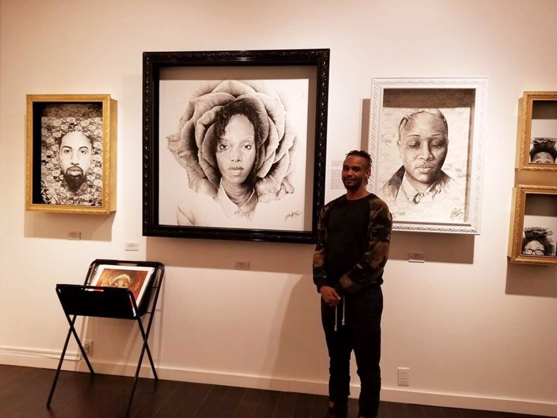 USACE Omaha District Visual Information Special Jeremy Bell stands in front of five of his original works at the Michael Birawer Gallery in Seattle Feb. 2018. (Courtesy photo)
