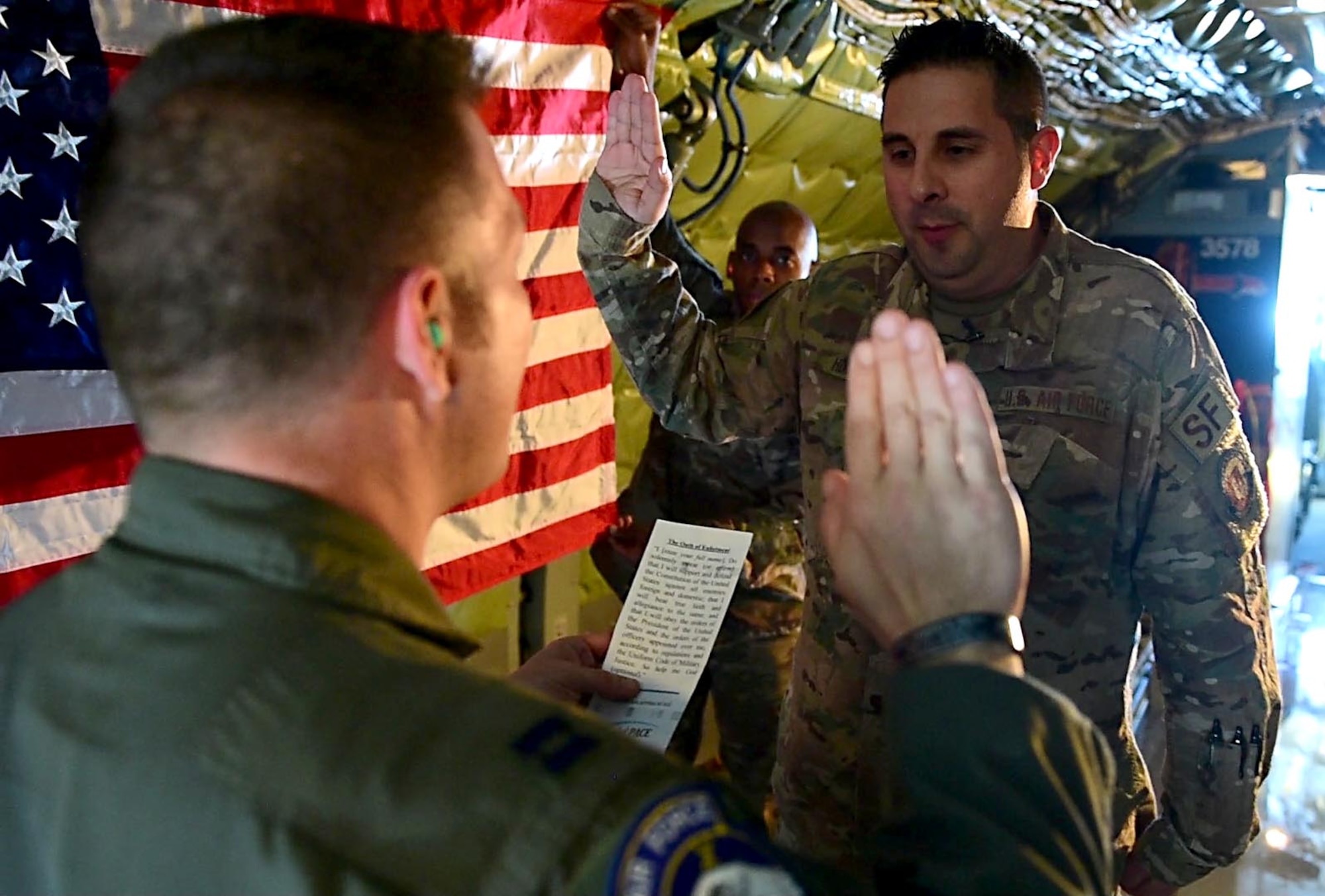 Air Force Master Sgt. William Hinchcliff, 31st Security Forces Squadron operations non-commissioned officer in charge, reenlists aboard a KC-135 Stratotanker over the Adriatic Sea, Italy, Feb. 22, 2019. Hinchcliff dedicated the reenlistment to his father-in-law, who served as a crew chief for KC-135s during his twenty year Air Force career. (U.S. Air Force photo by Staff Sgt. Tory Cusimano)