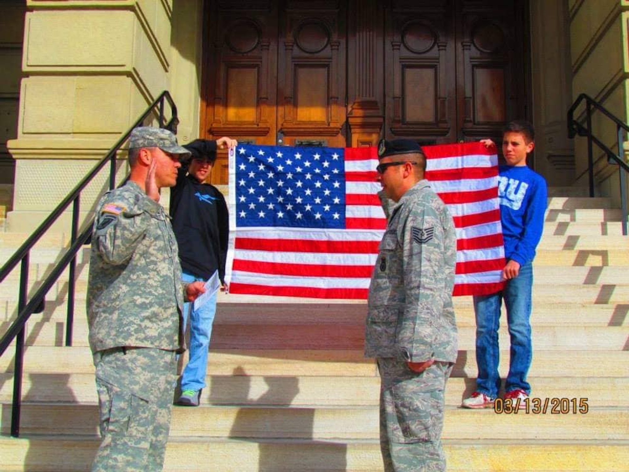 Tech. Sgt. William Hinchcliff reenlists on the capitol steps in Cheyenne, Wyoming, Mar. 13, 2015. (Courtesy photo)