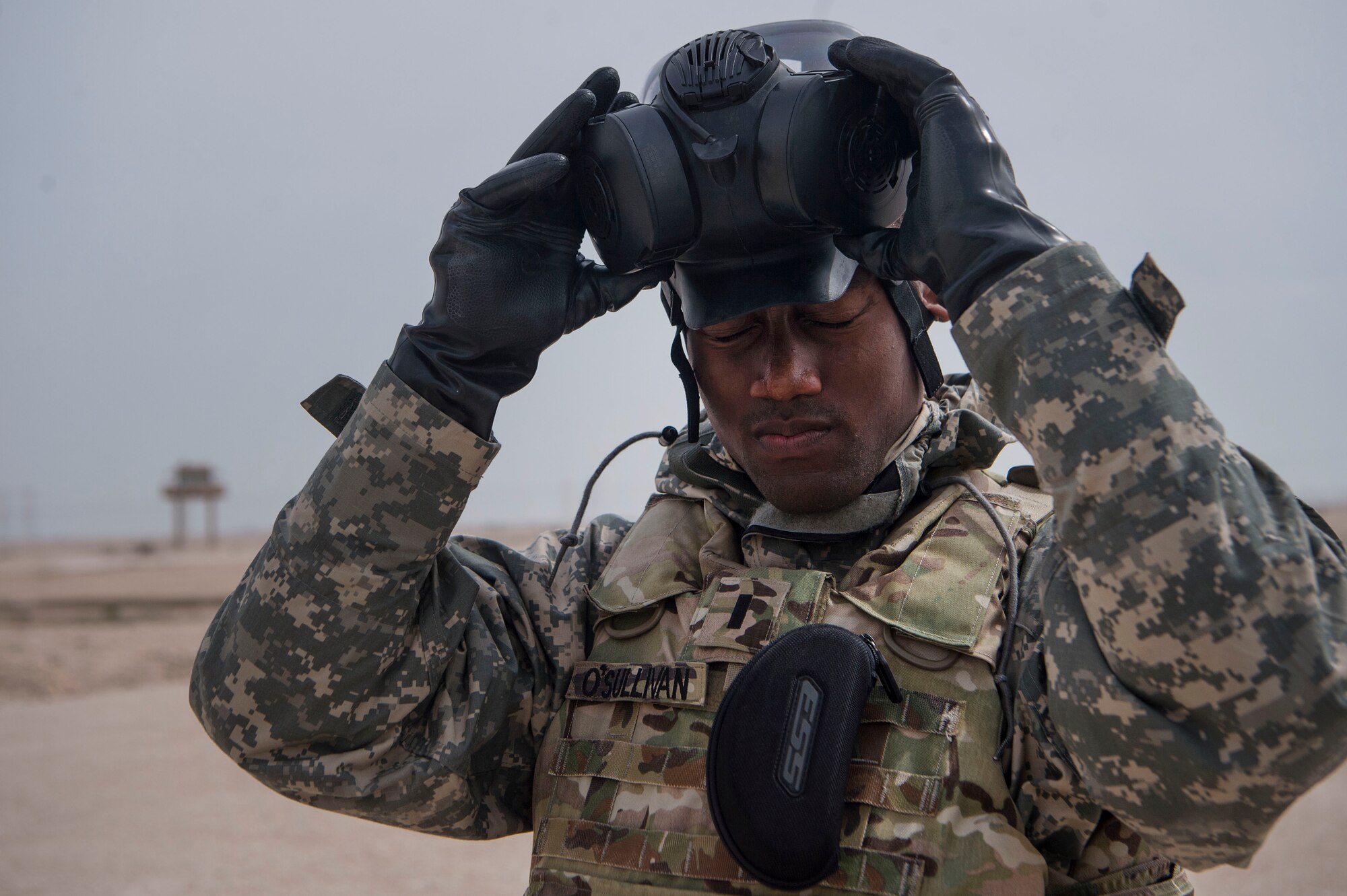 U.S. Army 1st Lt. Christopher O’Sullivan, 1st Battalion, 43rd Air Defense Artillery (ADA) regiment, 11th ADA Brigade executive officer, takes off Mission Oriented Protective Posture (MOPP) gear during a joint decontamination exercise Feb. 22, 2019, at Al Udeid Air Base, Qatar. U.S. Air Force and Army participants from the 379th Expeditionary Civil Engineer Squadron and the 1-43rd ADA, shared Chemical, Biological, Radiological, Nuclear, and high yield explosives (CBRNE) best practices, and tested their response proficiency during the training. The event was the conclusion of a four phase training curriculum. (U.S. Air Force photo by Tech. Sgt. Christopher Hubenthal)