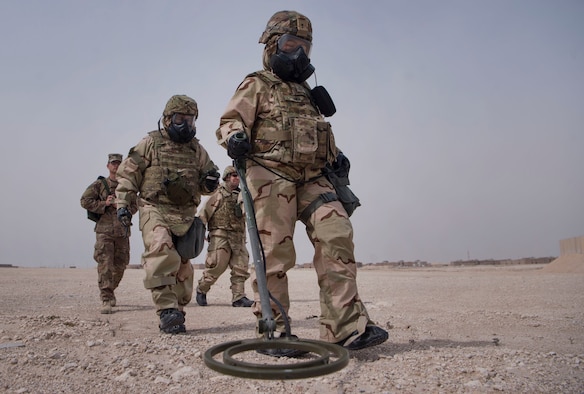 U.S. Army Pfc. Diamond Her (center), 1st Battalion, 43rd Air Defense Artillery (ADA) regiment, 11th ADA Brigade unit supply specialist, and U.S. Air Force Master Sgt. Brett Sanchez, 379th Expeditionary Civil Engineer Squadron (ECES) emergency management Chemical, Biological, Radiological, Nuclear, and high yield explosives (CBRNE) response NCO in charge, conduct a ground survey during a joint decontamination exercise Feb. 22, 2019, at Al Udeid Air Base, Qatar. U.S. Air Force and Army participants from the 379th ECES and the 1-43rd ADA, shared Chemical, Biological, Radiological, Nuclear, and high yield explosives (CBRNE) best practices, and tested their response proficiency during the training. The event was the conclusion of a four phase training curriculum. (U.S. Air Force photo by Tech. Sgt. Christopher Hubenthal)