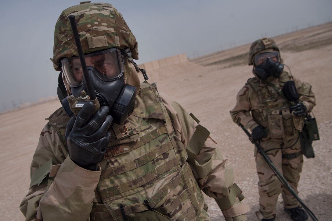 U.S. Air Force Master Sgt. Brett Sanchez, 379th Expeditionary Civil Engineer Squadron emergency management Chemical, Biological, Radiological, Nuclear, and high yield explosives (CBRNE) response NCO in charge, communicates with a radio alongside U.S. Army Pfc. Diamond Her, 1st Battalion, 43rd Air Defense Artillery (ADA) regiment, 11th ADA Brigade unit supply specialist, during a ground survey as part of a joint decontamination exercise Feb. 22, 2019, at Al Udeid Air Base, Qatar. U.S. Air Force and Army participants from the 379th ECES and the 1-43rd ADA, shared Chemical, Biological, Radiological, Nuclear, and high yield explosives (CBRNE) best practices, and tested their response proficiency during the training. The event was the conclusion of a four phase training curriculum. (U.S. Air Force photo by Tech. Sgt. Christopher Hubenthal)