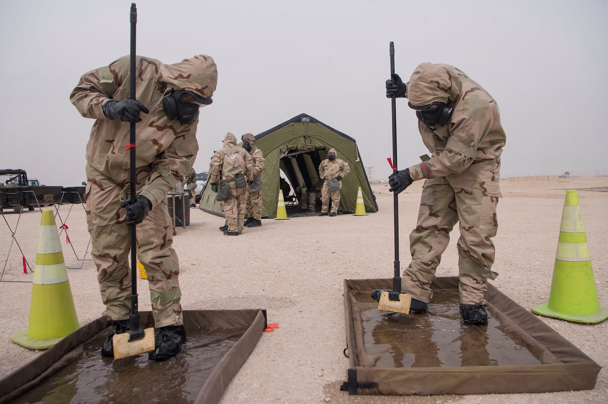 U.S. Army Soldiers of the 1st Battalion, 43rd Air Defense Artillery (ADA) regiment, 11th ADA Brigade, perform Chemical, Biological, Radiological, Nuclear, and high yield explosives (CBRNE) decontamination techniques during a ground survey as part of a joint decontamination exercise Feb. 22, 2019, at Al Udeid Air Base, Qatar. U.S. Air Force and Army participants from the 379th Expeditionary Civil Engineer Squadron and the 1-43rd ADA, shared CBRNE best practices, and tested their response proficiency during the training. The event was the conclusion of a four phase training curriculum. (U.S. Air Force photo by Tech. Sgt. Christopher Hubenthal)