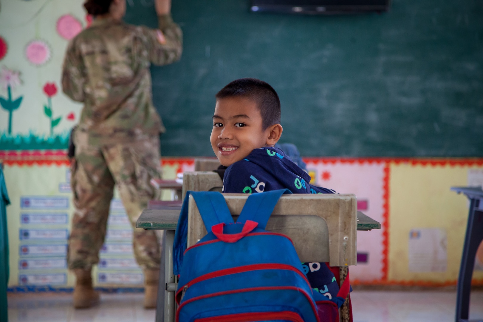 A student smiles to the camera during a class taught by Pvt. 1st. Class Ashley Firchau, 176th Engineer Company, Washington National Guard at the Bankoh-I-Duan School in the Tak Province, Kingdom of Thailand, Jan. 30, 2019.