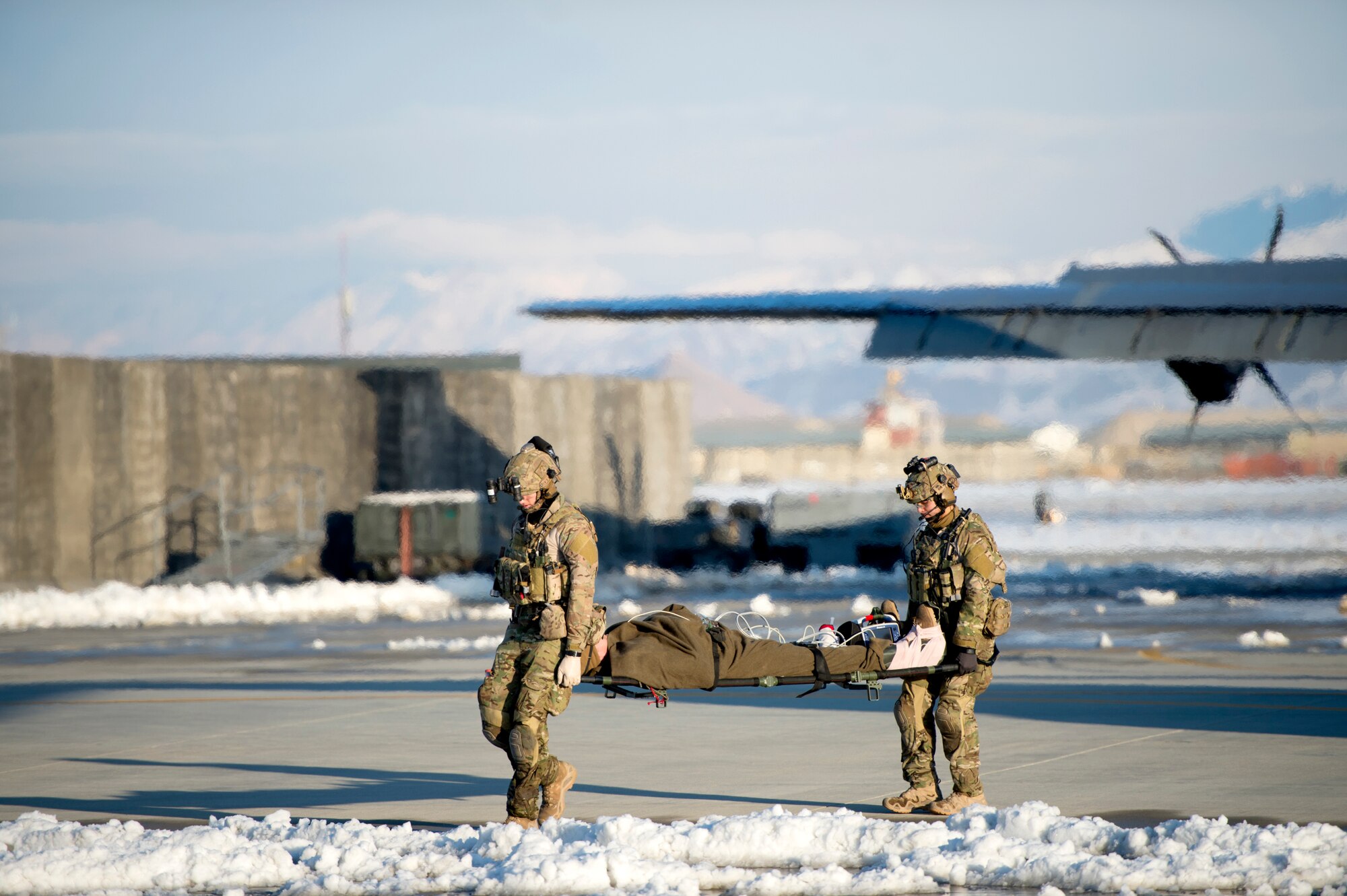 U.S. Air Force Airmen assigned to the 455th Expeditionary Aeromedical Evacuation Squadron participated in a training exercise with Airmen from the 83rd Expeditionary Rescue Squadron, Feb. 21, 2019. Airmen simulated the process of caring for individuals from point of injury until they were cared for in the air and transported to a medical facility. (U.S. Air Force photo by Senior Airman Rito Smith)