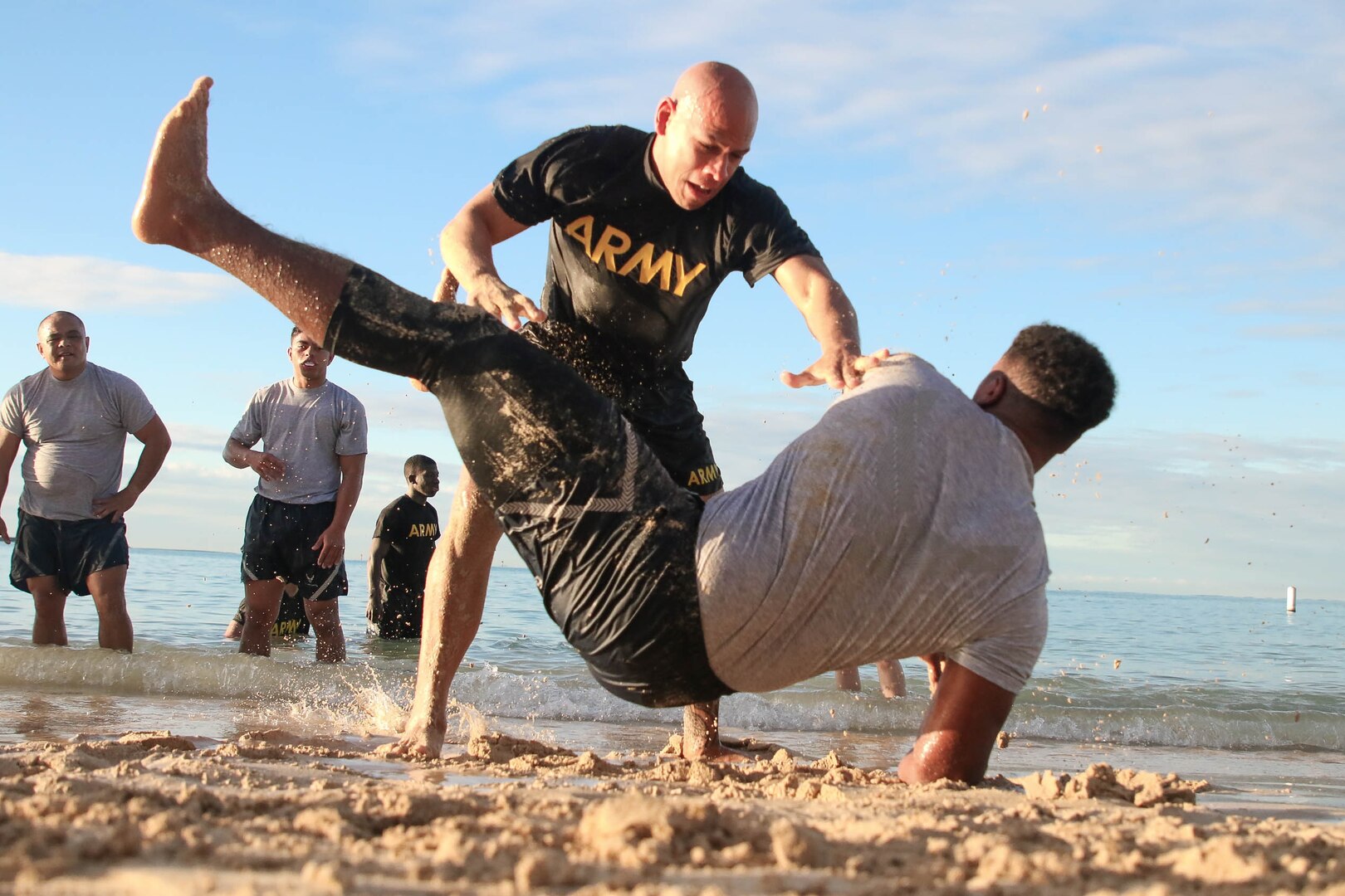 A U.S. Army Soldier takes down an U.S. Air Force Airman during a U.S. Army Combatives course at Joint Base Pearl Harbor-Hickam, Hawaii.