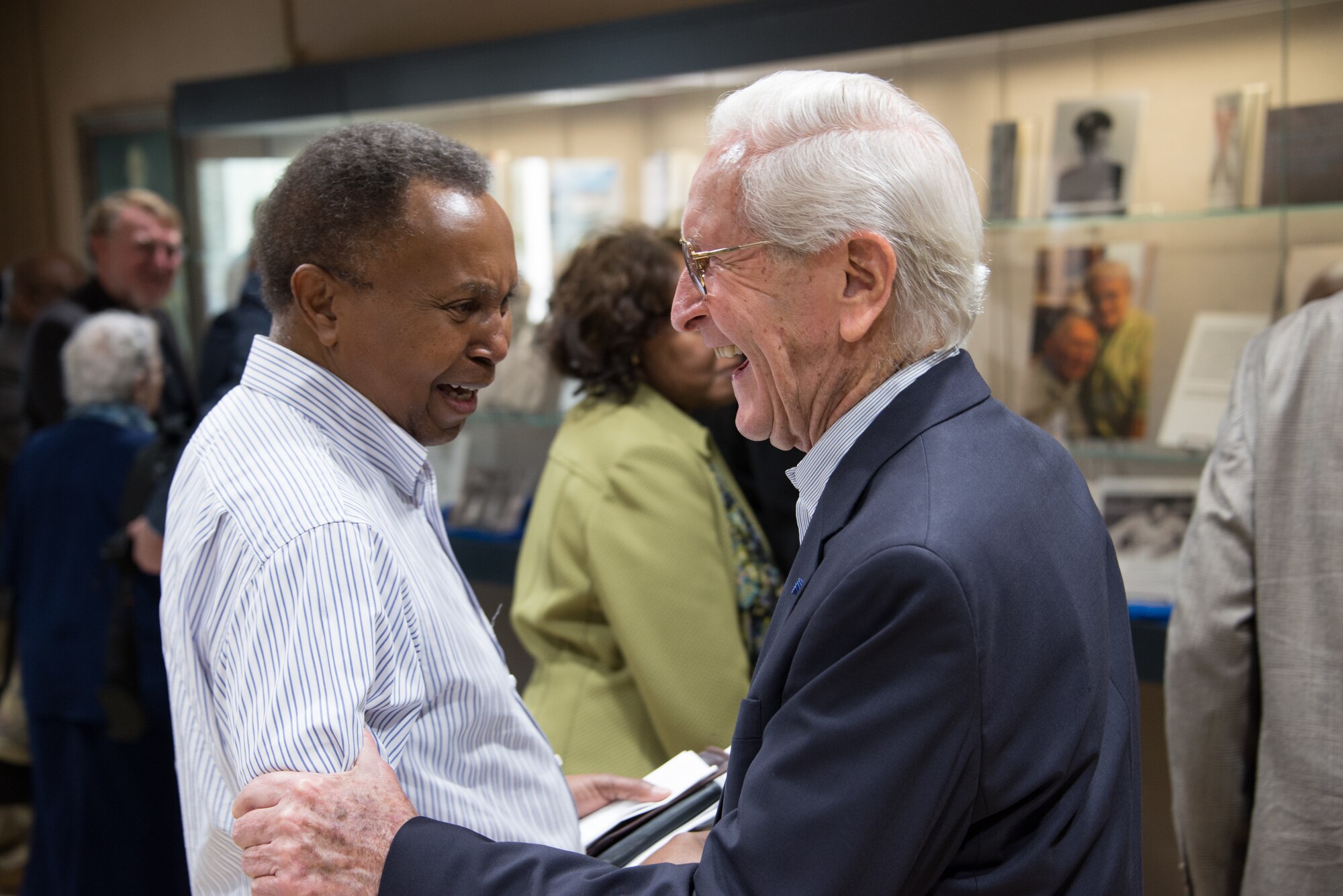 Two attendees of the “Maxwell and the Movement” exhibit catch up with one another at the Muir S. Fairchild Research Information Center, Feb. 21, 2019, Maxwell Air Force Base, Alabama. The attendees of the event included people from the base and Montgomery communities and even as far as Atlanta. (U.S. Air Force photo by Senior Airman Francisco Melendez – Espinosa)