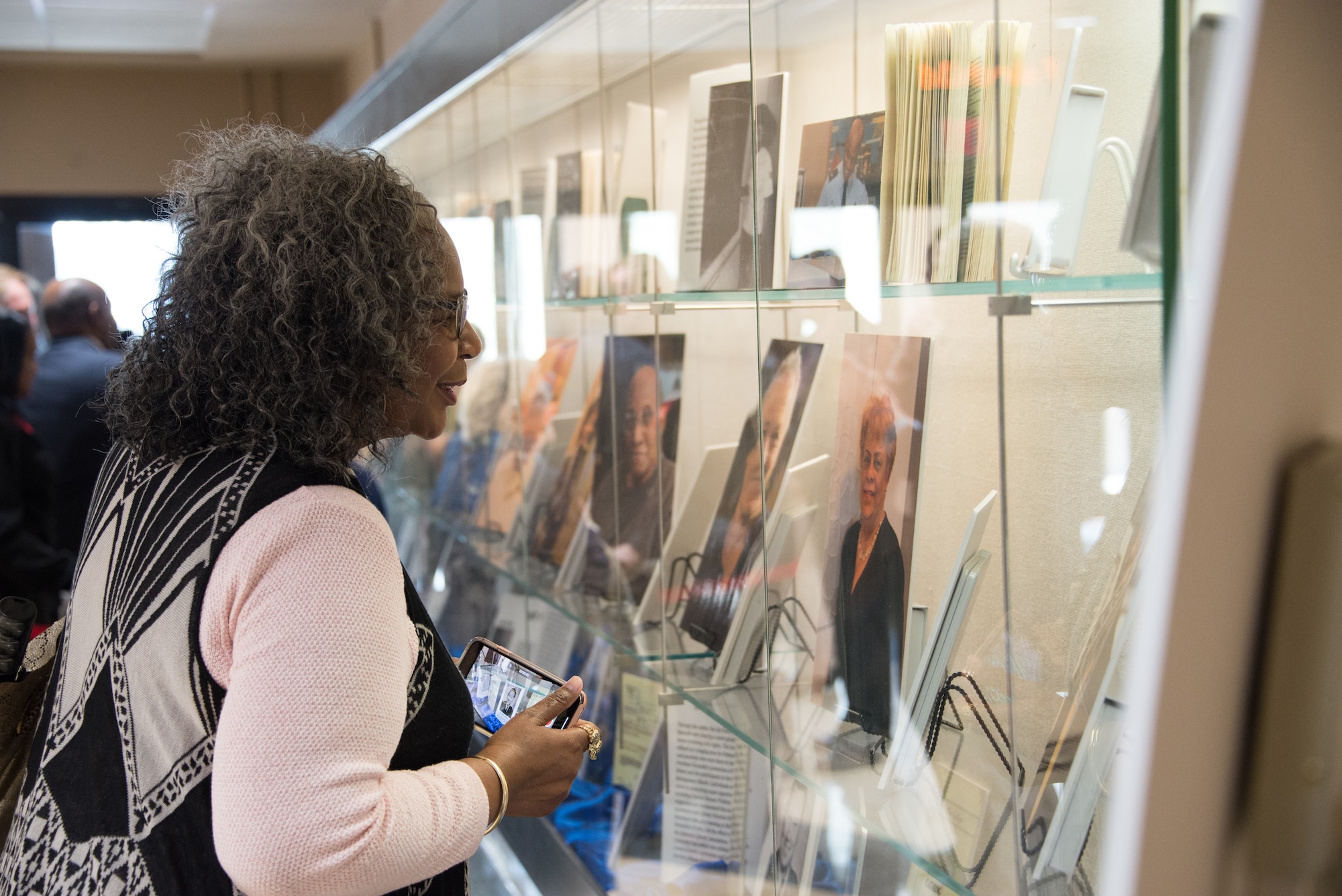 An attendee of the “Maxwell and the Movement” exhibit looks over the pictures on display at the Muir S. Fairchild Research Information Center, Feb. 21, 2019, Maxwell Air Force Base, Alabama. The exhibit displayed photos and writings highlighting the successes and challenges overcome by African – Americans here at Maxwell. (U.S. Air Force photo by Senior Airman Francisco Melendez – Espinosa)