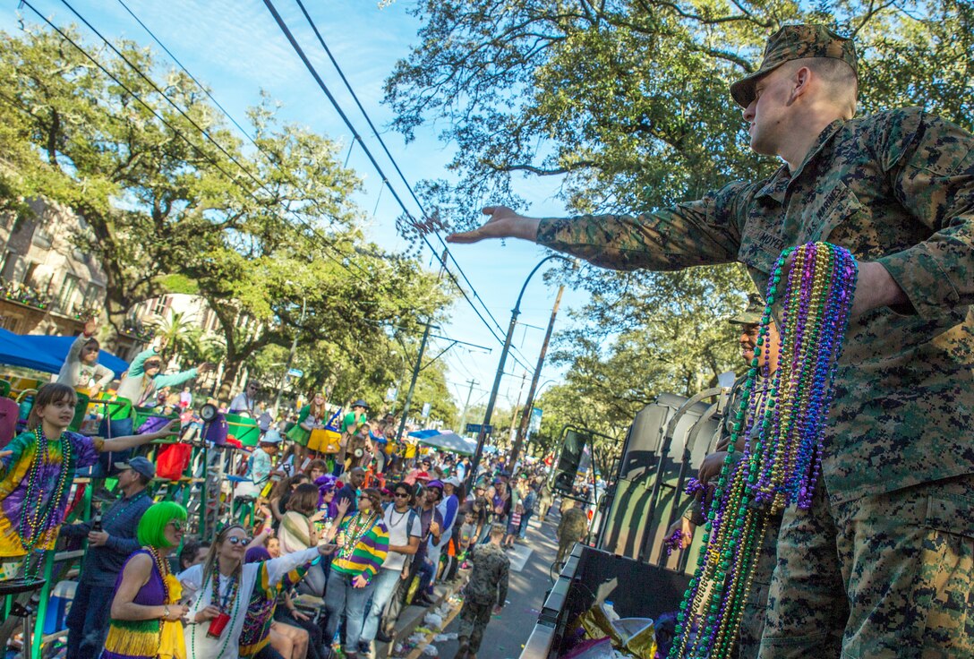 Cpl. Brian N. Moyer with Headquarters Battalion, Marine Forces Reserve, participates in the Krewe of Alla Mardi Gras parade in New Orleans, Feb. 24, 2019. The Marines had the opportunity to participate in the 2019 Mardi Gras festivities to showcase the military presence in the New Orleans area in support of community outreach events. (U.S. Marine Corps photo by Sgt. Markeith D. Hall/Released)