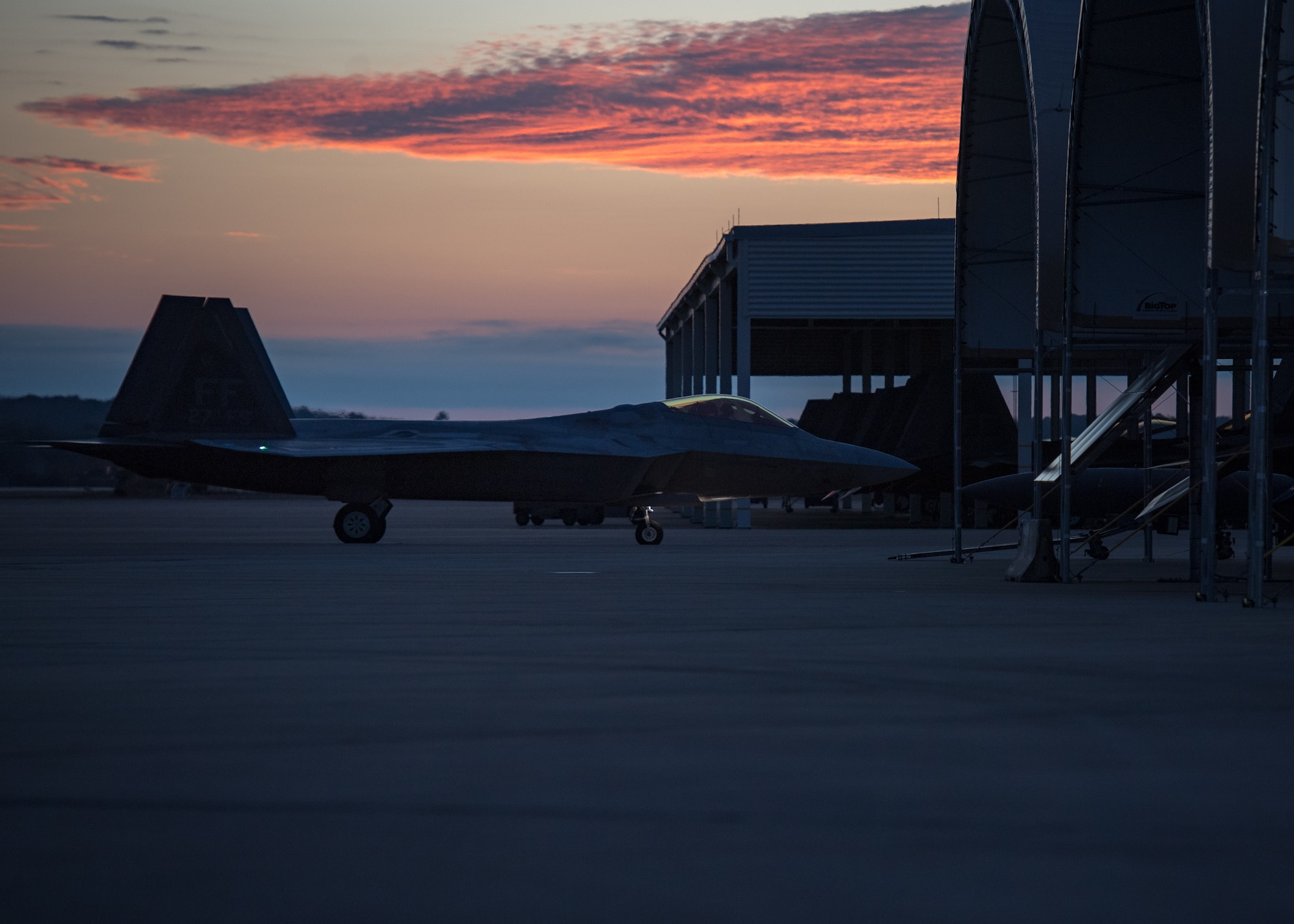 A U.S. Air Force F-22 Raptor taxis by the sunshades at Joint Base Langley-Eustis, Virginia, Feb. 21, 2018.