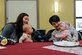 Joint Base Charleston spouses Jordan Ashley, left, and Hannah Wilson, right, let their five-month-old daughters, Nora and Maeve, interact with each other Feb. 13, 2019, during a Key Spouse luncheon at the base chapel on Joint Base Charleston, S.C.