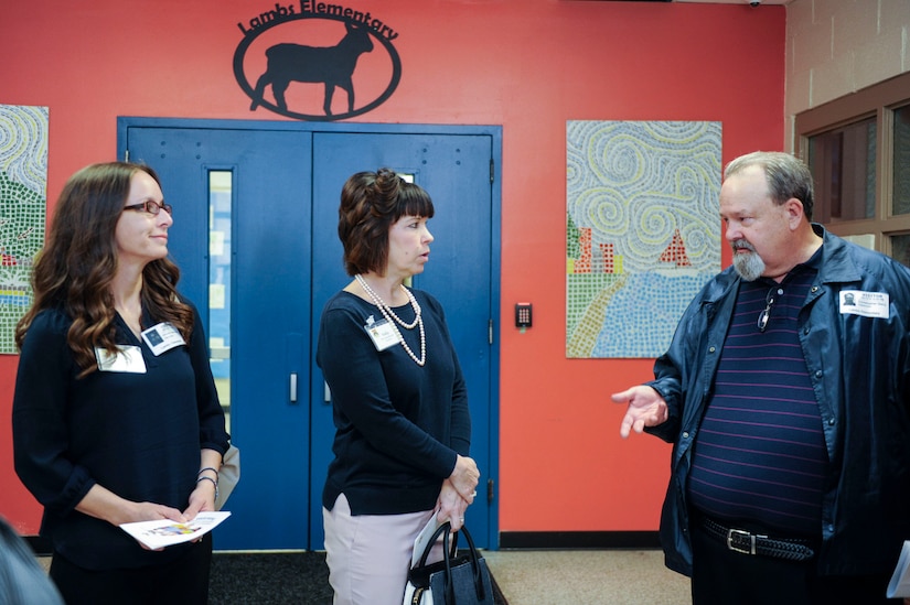 Amanda Zumbrunnen, 437th Airlift Wing Key Spouse, left, and Kelly Barrett, 18th Air Force Key Spouse, listen to Chris Gerry, 628th Force Support Squadron school liaison officer, talk about the importance of rapport with local schools for military families Feb. 13, 2019, at Lambs Elementary School in Charleston, S.C.