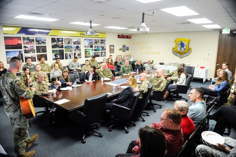 Staff Sgt. Trevor Childs, assigned to Joint Base Charleston’s protocol office, plays “Can’t Help Falling in Love” by Elvis Presley for the family members present during a luncheon in the 437th Airlift Wing conference room Feb. 14, 2019, on Joint Base Charleston, S.C.